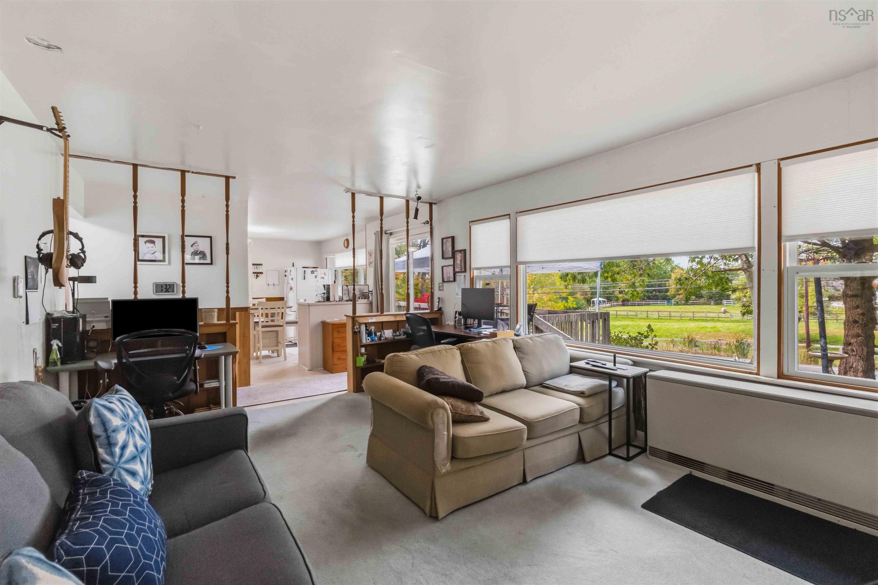 5376 Highway 2 Highway, Grand Lake, NS (MLS® 202625929) — Expansive windows offering exterior natural light, integrated wood-finish room dividers, and neutral wall tones