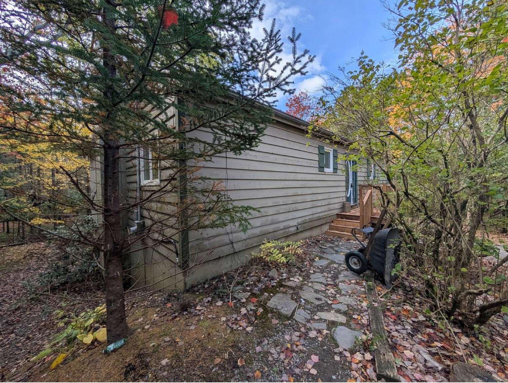 19 Foster Avenue, Fall River, NS (MLS® 202625937) — Horizontal siding exterior featuring a natural stone pathway and wooden deck entry