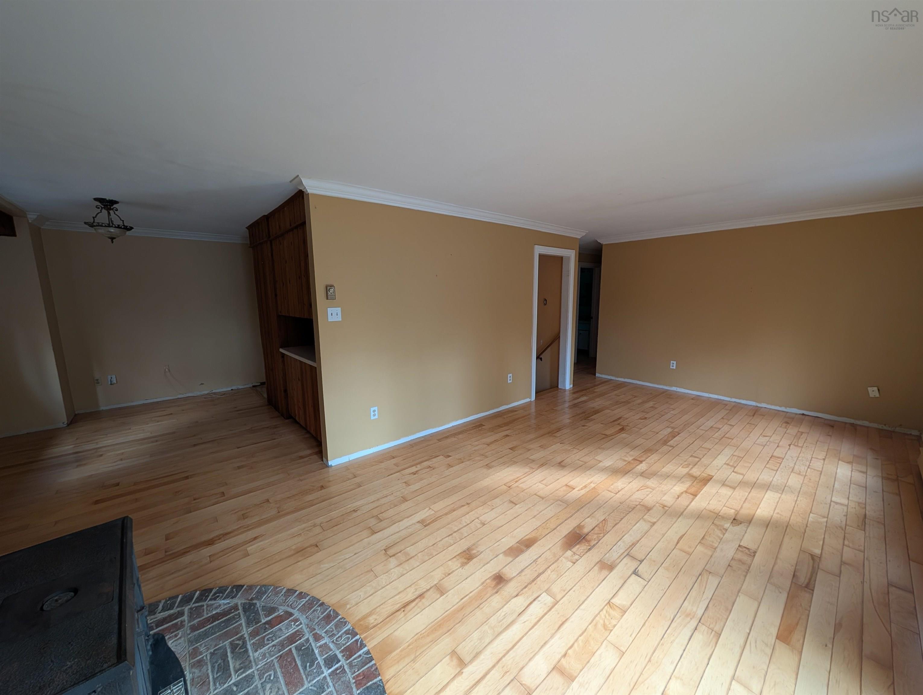 19 Foster Avenue, Fall River, NS (MLS® 202625937) — Wood-finish flooring, built-in wooden cabinetry, brick hearth, and crown molding