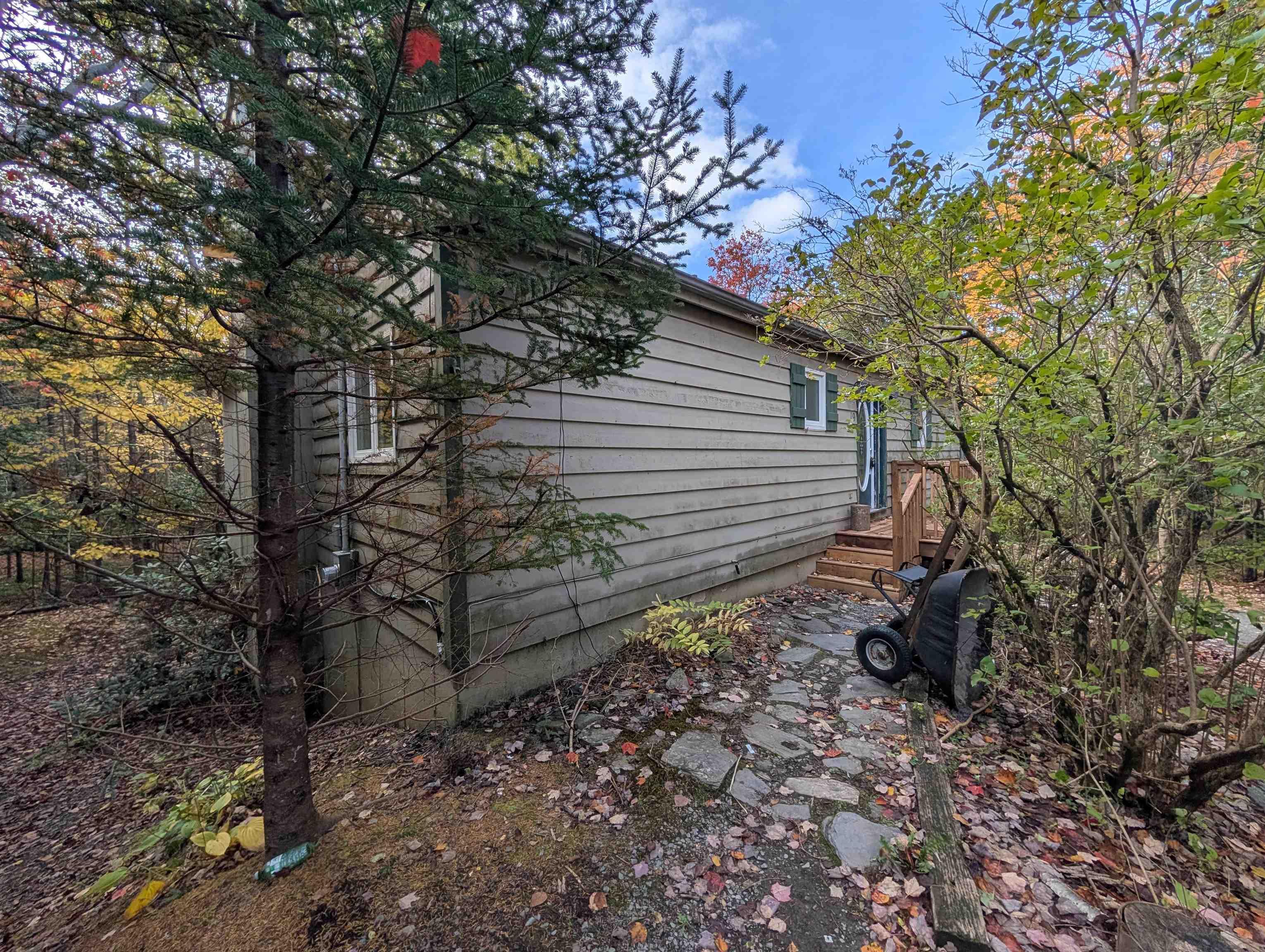 19 Foster Avenue, Fall River, NS (MLS® 202625937) — Exterior siding featuring horizontal lap boards, natural stone pathway, and wood-framed entry steps