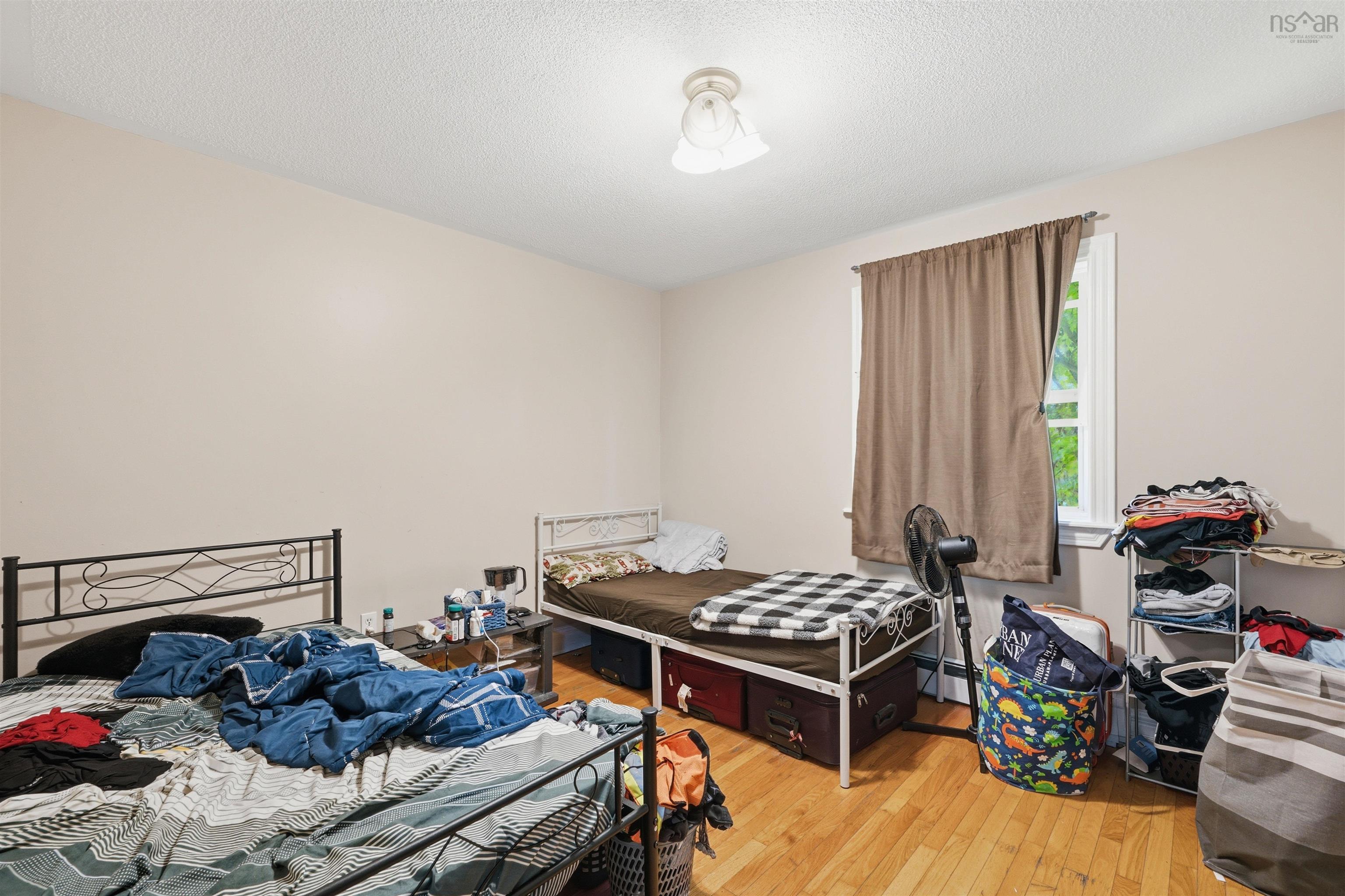 34 Lancaster Drive, Clayton Park, NS (MLS® 202626151) — Room featuring wood-finish flooring, a single-window configuration, and a multi-globe ceiling-mounted light fixture