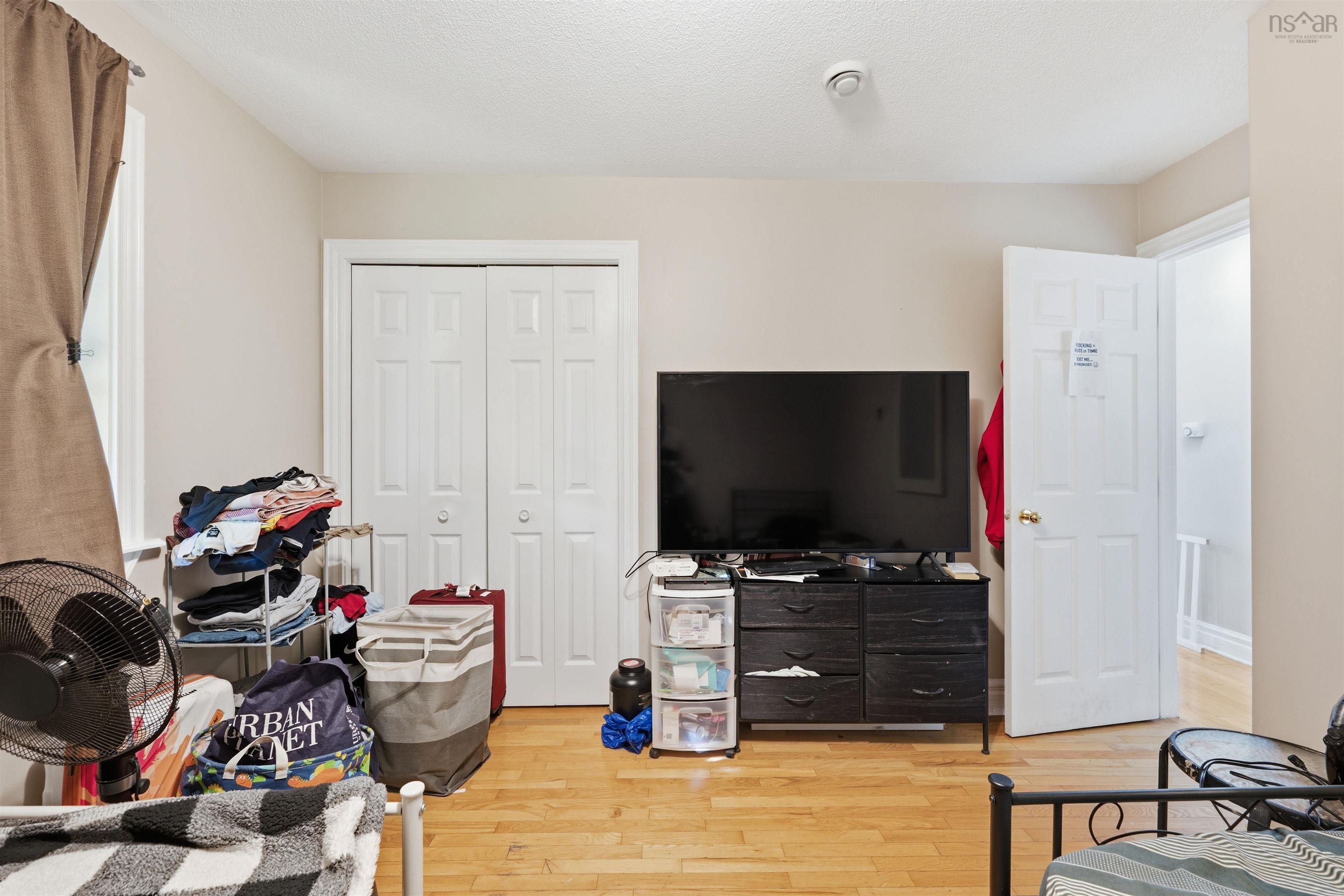34 Lancaster Drive, Clayton Park, NS (MLS® 202626151) — Room featuring wood-finish flooring and a double-door closet