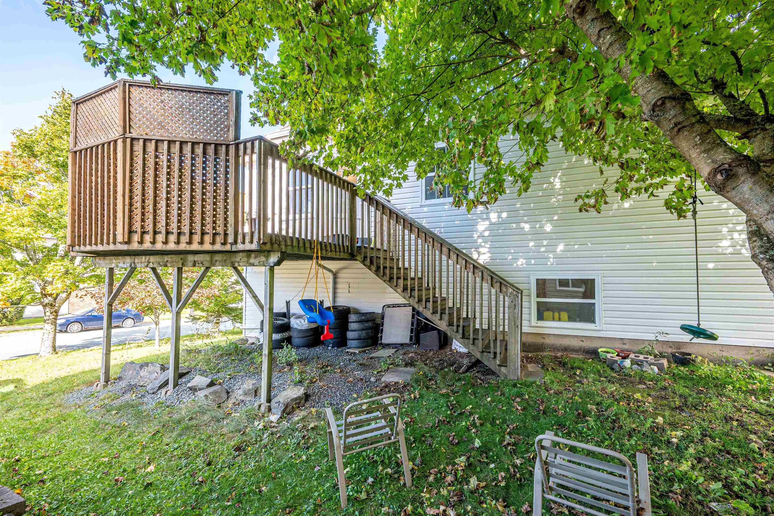 34 Lancaster Drive, Clayton Park, NS (MLS® 202626151) — Elevated wood deck featuring lattice privacy screening, railing, and stairs providing outdoor access