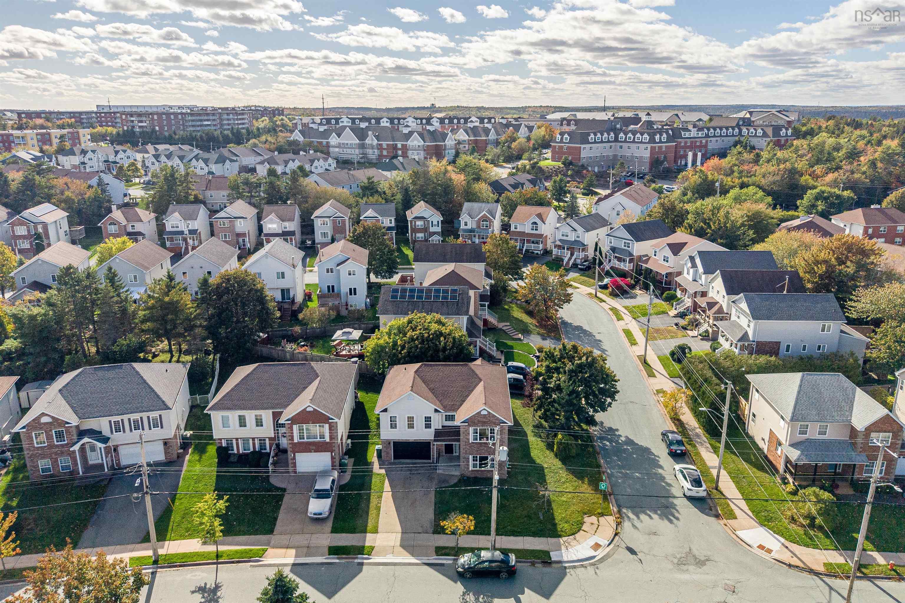 34 Lancaster Drive, Clayton Park, NS (MLS® 202626151) — Aerial perspective of a suburban neighborhood featuring paved streets, established tree canopy, and residential homes with shingled roofs and solar panel arrays