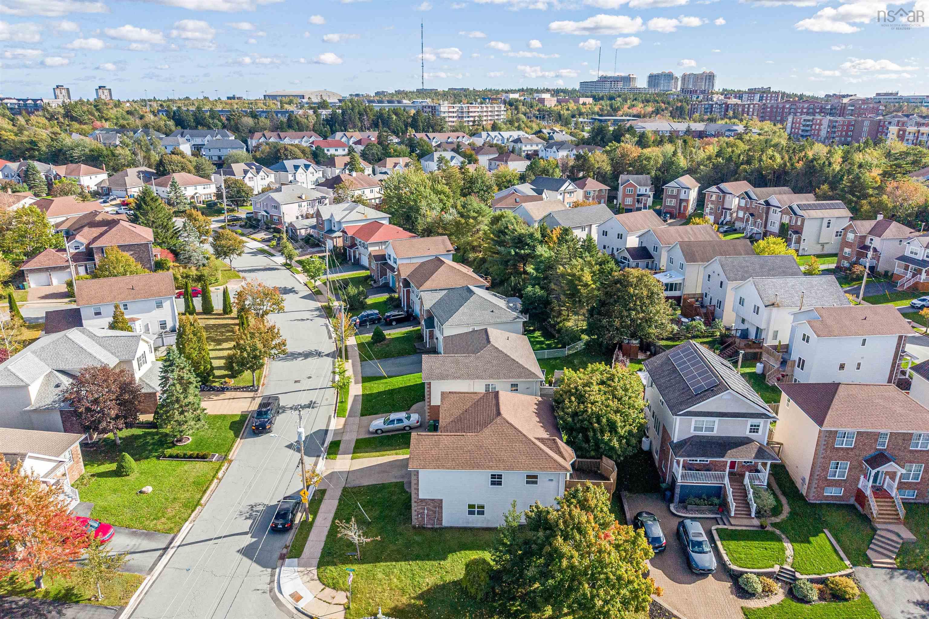 34 Lancaster Drive, Clayton Park, NS (MLS® 202626151) — Aerial perspective of a suburban neighborhood featuring residential dwellings, paved street access, mature trees, and installed solar panels