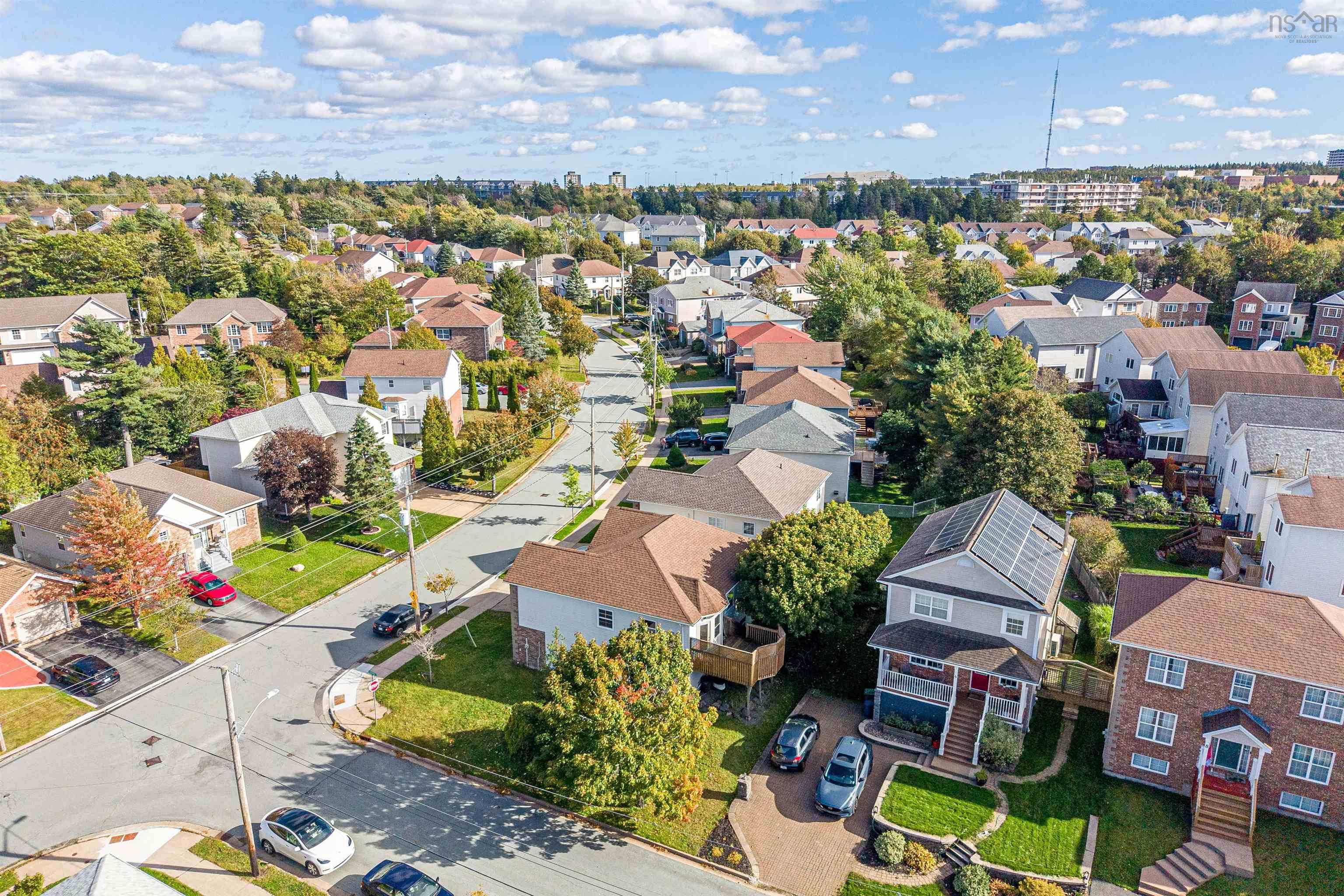 34 Lancaster Drive, Clayton Park, NS (MLS® 202626151) — Aerial view of a residential neighborhood featuring established tree canopy, paved suburban streets, and multi-level homes with varied rooflines