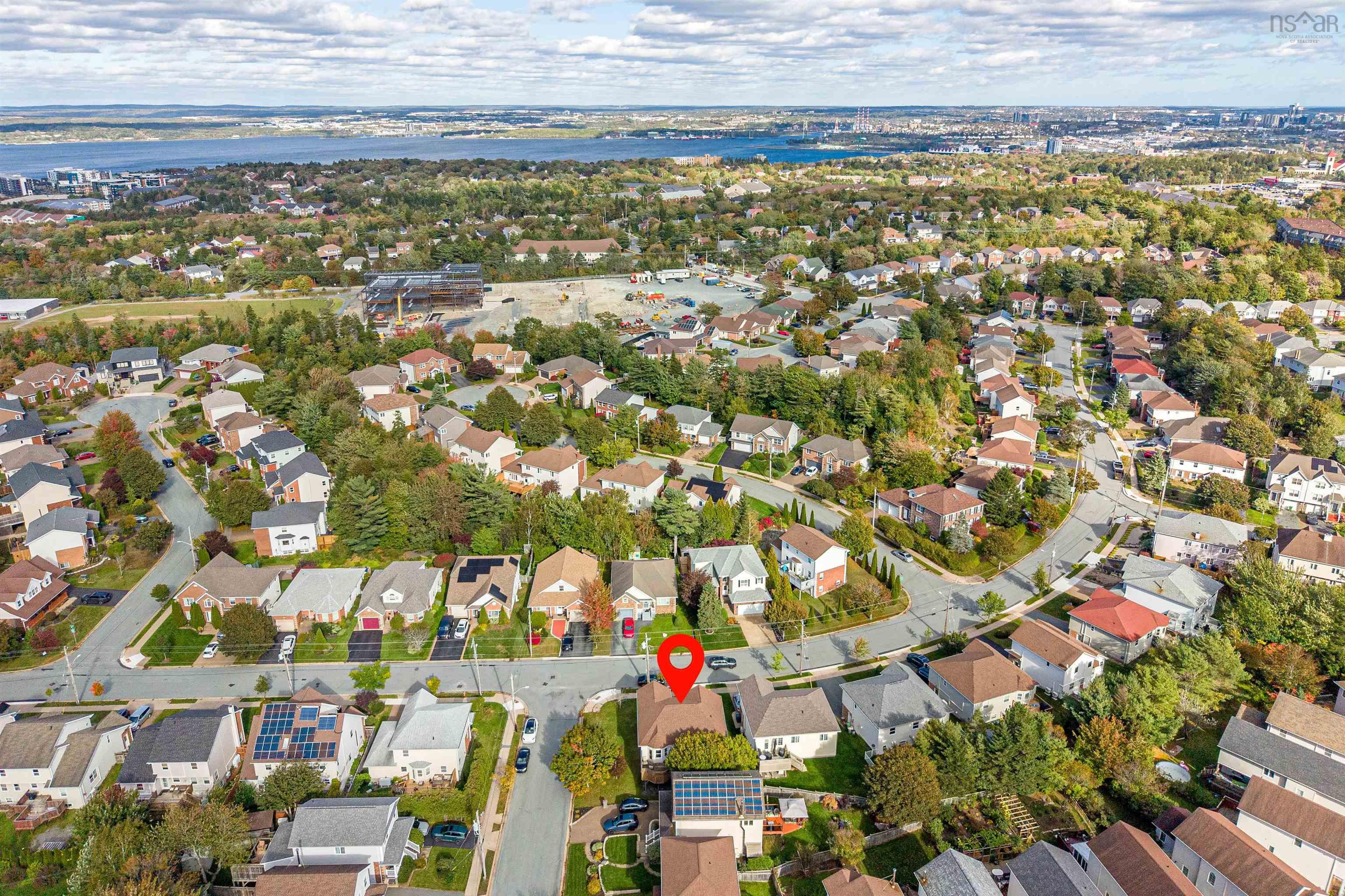 34 Lancaster Drive, Clayton Park, NS (MLS® 202626151) — Aerial perspective featuring solar panel installations, asphalt shingled roofing, mature landscaping, and proximity to the waterfront