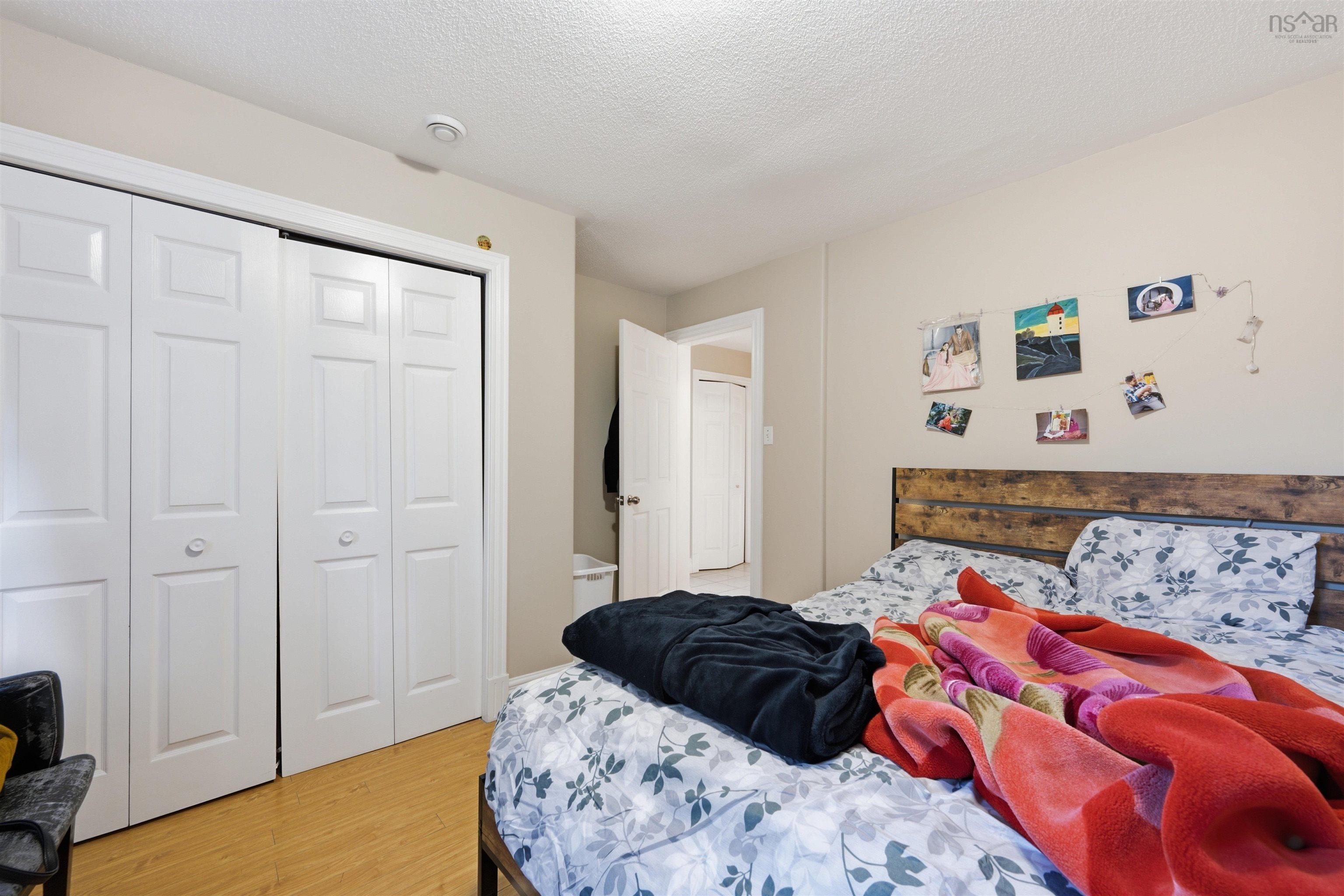 34 Lancaster Drive, Clayton Park, NS (MLS® 202626151) — Neutral wall color, wood-finish flooring, and double-panel closet doors