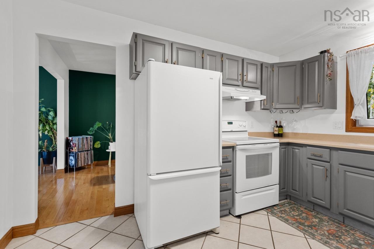 24 Rossi Drive, Dartmouth, NS (MLS® 202626410) — Kitchen featuring grey cabinetry, white appliances, solid-surface countertops, and tile flooring