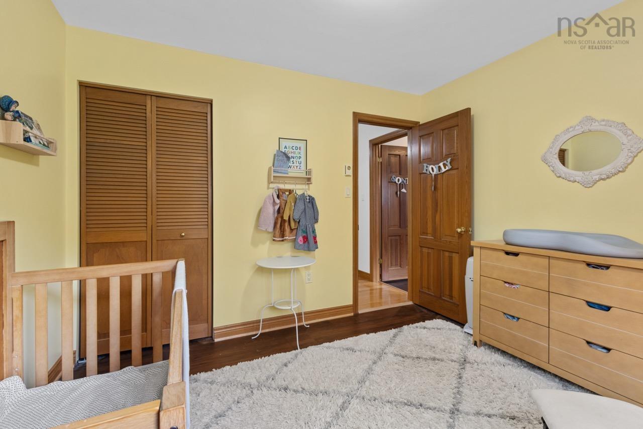 24 Rossi Drive, Dartmouth, NS (MLS® 202626410) — Wood-finish flooring, solid wood six-panel door, and louvered double-door closet