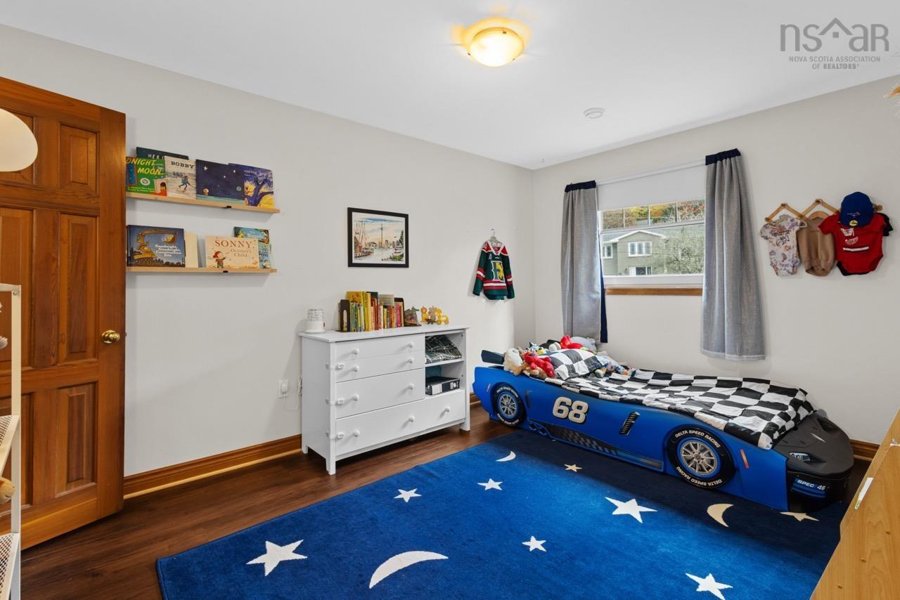 24 Rossi Drive, Dartmouth, NS (MLS® 202626410) — Wood-finish flooring, solid wood six-panel door, neutral wall finish, and flush-mount ceiling lighting