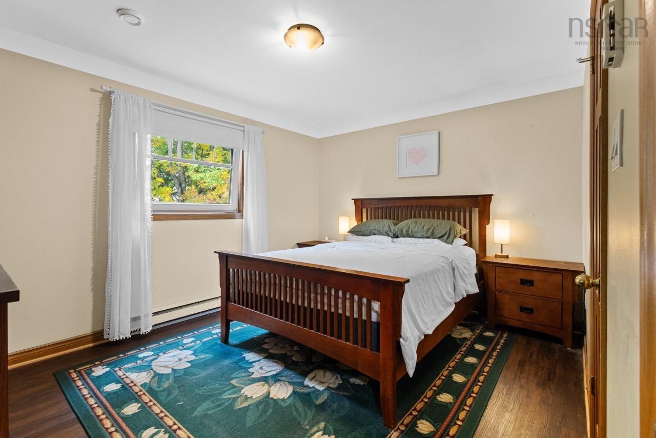 24 Rossi Drive, Dartmouth, NS (MLS® 202626410) — Bedroom featuring wood-finish flooring, a horizontal single-pane window, and a central ceiling-mounted light fixture