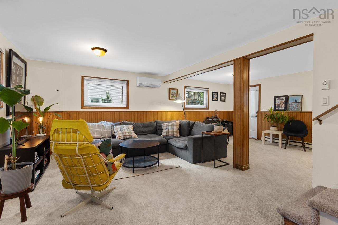 24 Rossi Drive, Dartmouth, NS (MLS® 202626410) — Interior space featuring wood wainscoting, neutral carpeting, a wall-mounted ductless mini-split system, and a structural wooden support column