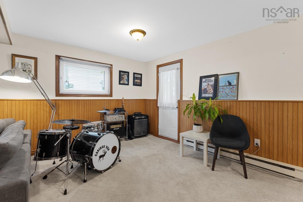24 Rossi Drive, Dartmouth, NS (MLS® 202626410) — Interior room featuring light-toned wall-to-wall carpeting, wood-finish wainscoting, and an exterior door with glass detailing