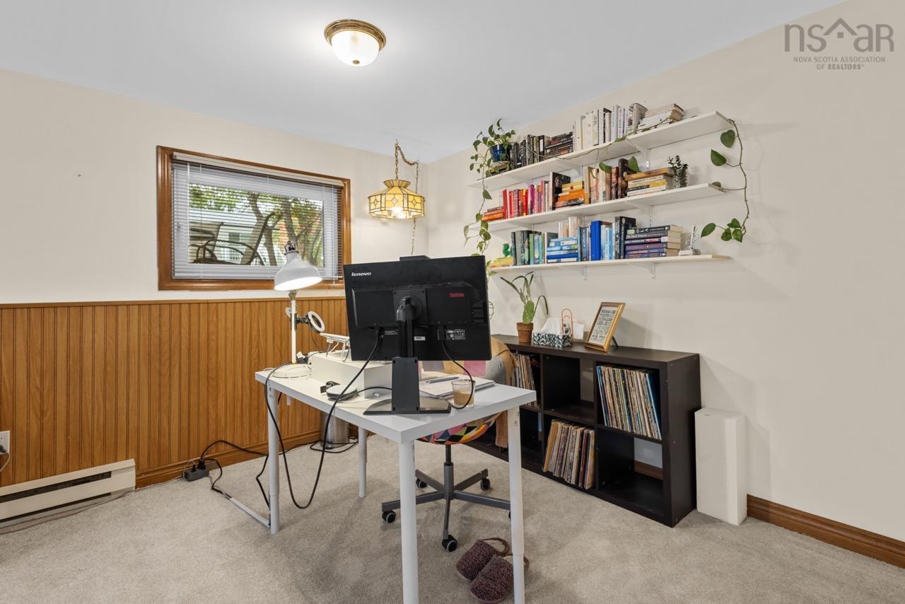 24 Rossi Drive, Dartmouth, NS (MLS® 202626410) — Room featuring wood-paneled wainscoting, wall-mounted shelving, neutral carpet flooring, and a decorative pendant light fixture