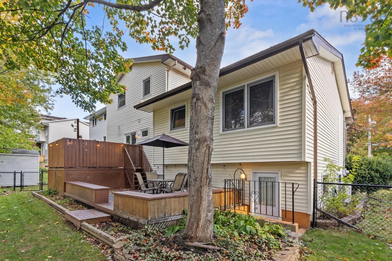 24 Rossi Drive, Dartmouth, NS (MLS® 202626410) — Multi-level wood deck featuring built-in bench seating, perimeter privacy lattice, and chain-link fenced backyard