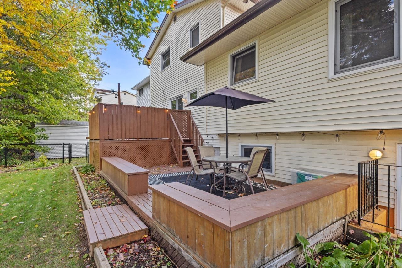 24 Rossi Drive, Dartmouth, NS (MLS® 202626410) — Multi-level wood deck featuring built-in bench seating, lattice privacy screening, and a staircase leading to the yard