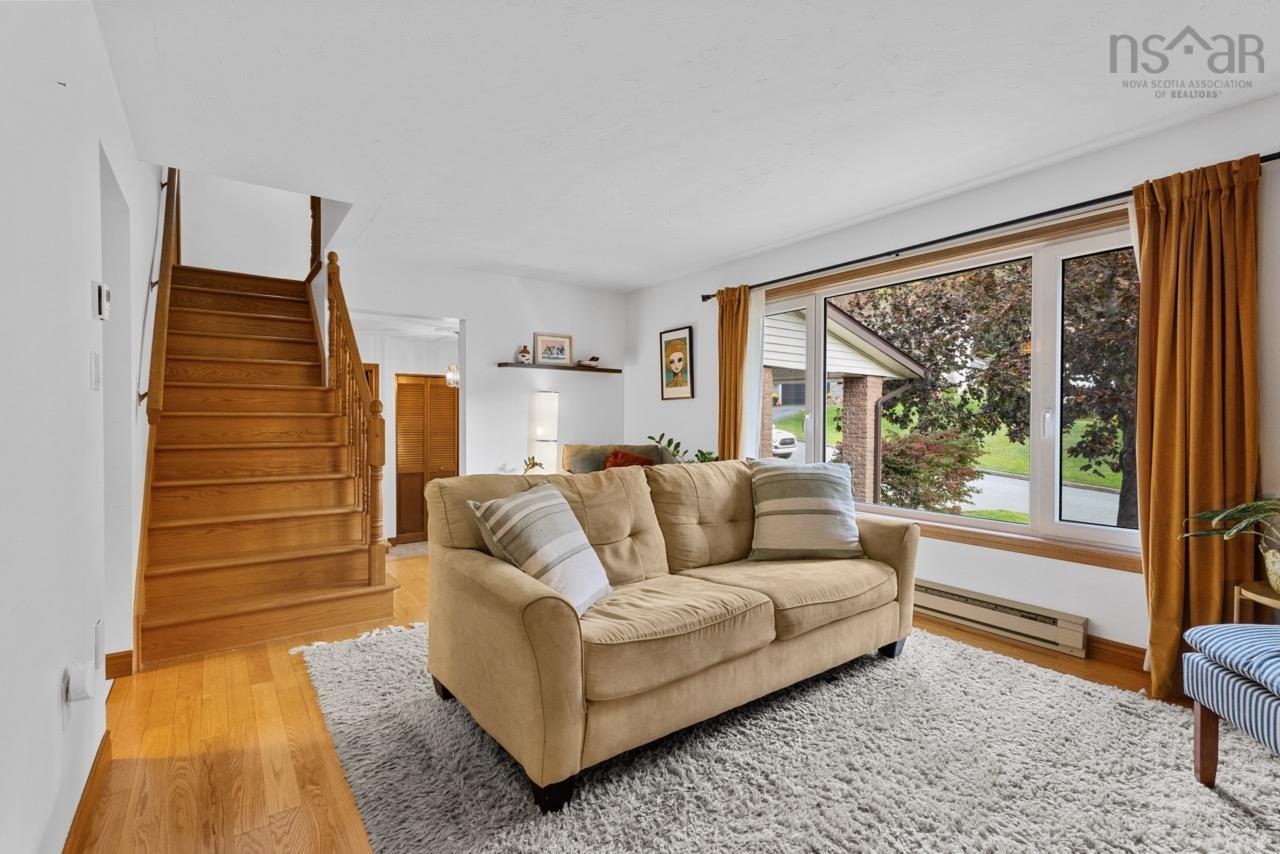 24 Rossi Drive, Dartmouth, NS (MLS® 202626410) — Wood-finish staircase with matching railing, wood-finish flooring, and expansive picture window