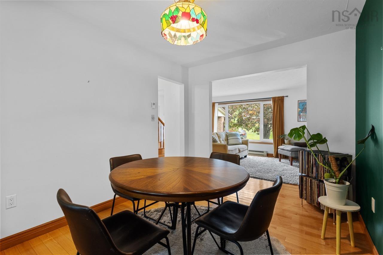 24 Rossi Drive, Dartmouth, NS (MLS® 202626410) — Stained-glass pendant light fixture, wood-finish flooring, and emerald green accent wall