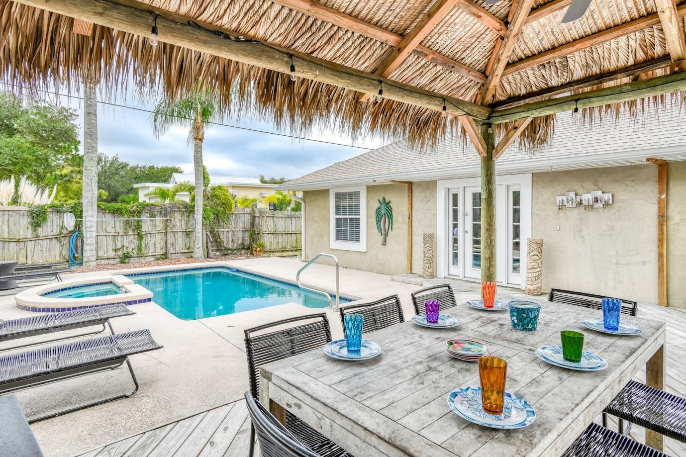 Welcome to “Tiki Time” – your private backyard oasis and the perfect blend of relaxation and investment opportunity! This beautifully maintained 4-bedroom, 2-bath home features a stunning outdoor retreat complete with a sparkling pool and spa, an oversized poolside tiki hut ideal for entertaining, and a cozy firepit for unforgettable evenings under the stars. Inside, the home shines with a thoughtfully remodeled open-concept kitchen featuring stainless steel appliances, granite countertops, and a convenient bonus bar/coffee station—perfect for hosting or everyday living. The split-bedroom floor plan offers privacy and functionality, with a spacious primary suite overlooking the pool, dual closets, and a beautifully updated bathroom with a large walk-in shower.