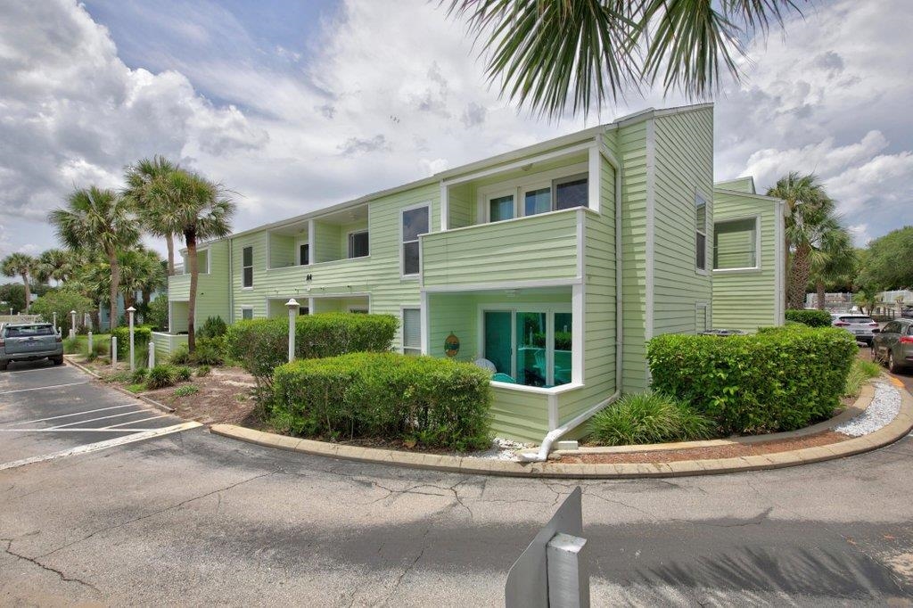 Welcome to your own slice of Old Florida paradise in the highly sought-after Quail Hollow community. This beautifully maintained 2-bedroom, 2-bath condominium offers the perfect blend of coastal charm, comfort, and investment potential. Ideally situated on the desirable south end of the complex, this residence captures refreshing ocean breezes year-round and provides a peaceful retreat just steps from the beach. Enjoy morning coffee or evening cocktails from either of the two private balconies while soaking in the relaxed island atmosphere. Inside, vaulted ceilings create a bright and spacious feel throughout the living areas. Recent upgrades include a new HVAC system as well as a new washer and dryer, offering peace of mind and convenience for years to come. The property is currently operating as a successful vacation rental, making it an excellent opportunity for investors, second-home buyers, or those seeking a full-time coastal residence.