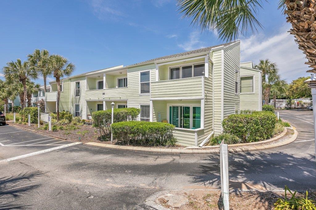 Welcome to your own slice of Old Florida paradise in the highly sought-after Quail Hollow community. This beautifully maintained 2-bedroom, 2-bath condominium offers the perfect blend of coastal charm, comfort, and investment potential. Ideally situated on the desirable south end of the complex, this residence captures refreshing ocean breezes year-round and provides a peaceful retreat just steps from the beach. Enjoy morning coffee or evening cocktails from either of the two private balconies while soaking in the relaxed island atmosphere. Inside, vaulted ceilings create a bright and spacious feel throughout the living areas. Recent upgrades include a new HVAC system as well as a new washer and dryer, offering peace of mind and convenience for years to come. The property is currently operating as a successful vacation rental, making it an excellent opportunity for investors, second-home buyers, or those seeking a full-time coastal residence.