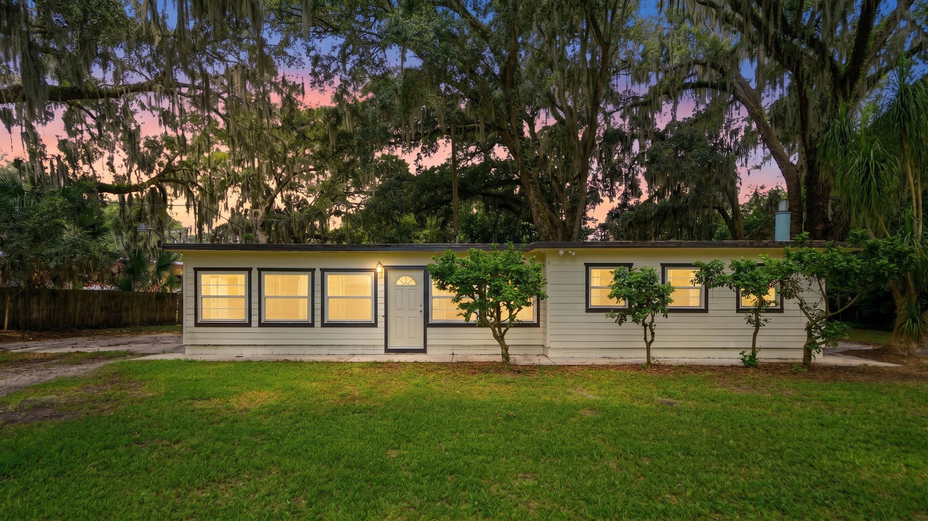 Single-story residence featuring light-colored siding and a dark trim roofline Front Of Structure