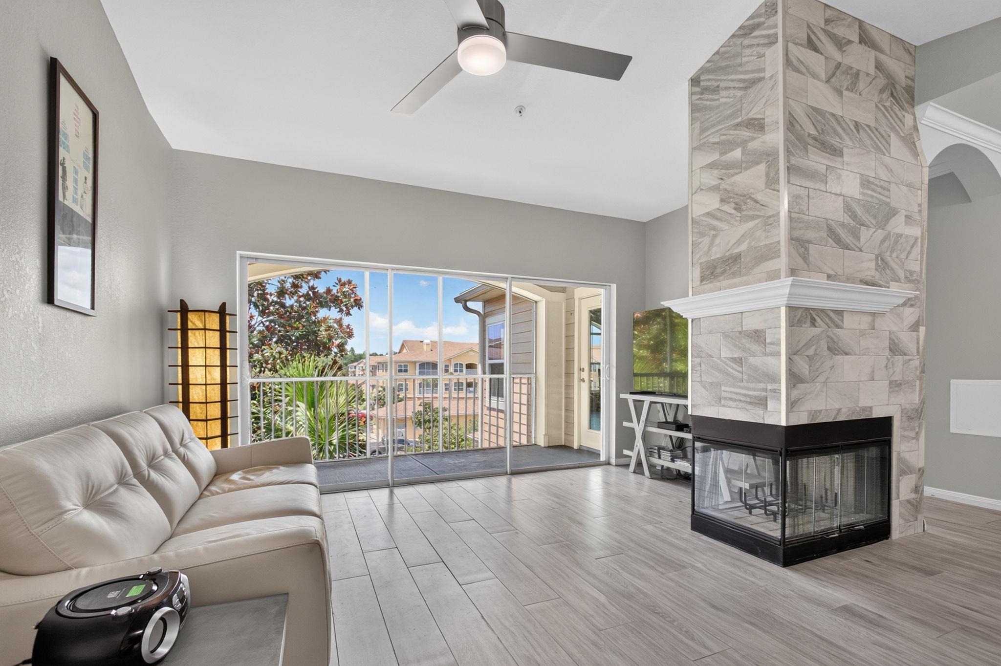 Open concept living area featuring wood-finish flooring and a ceiling fan Living Room