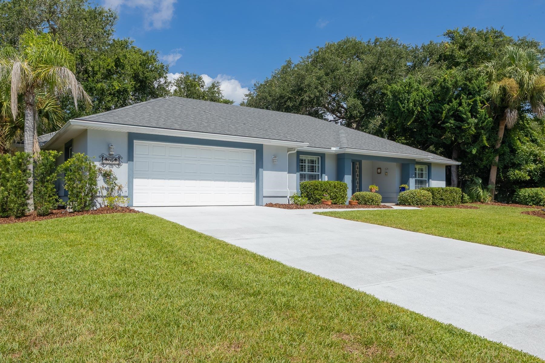 Single-story residence featuring a gray shingle roof and light blue siding with dark blue trim Front Of Structure
