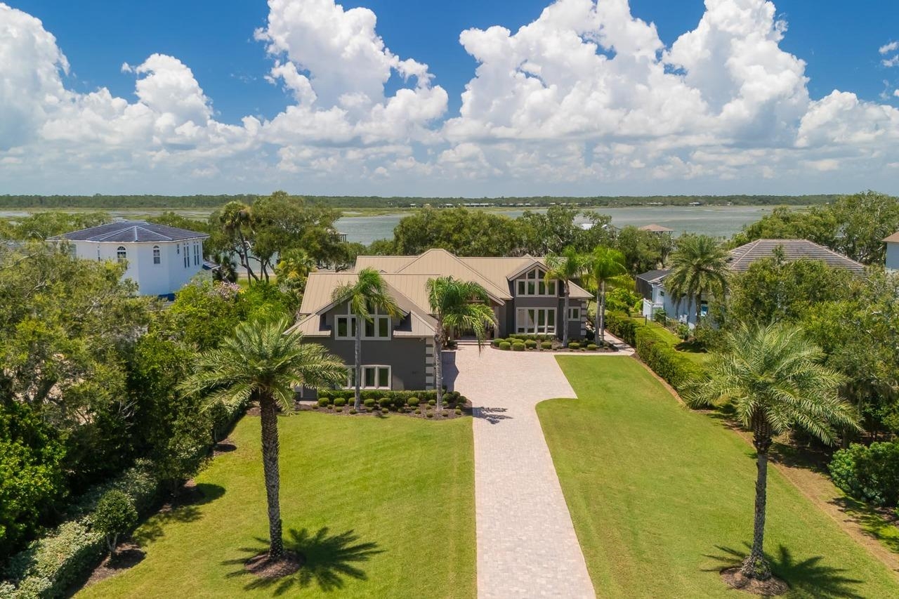 Contemporary-style residence with a neutral exterior and a metal roof Aerial View