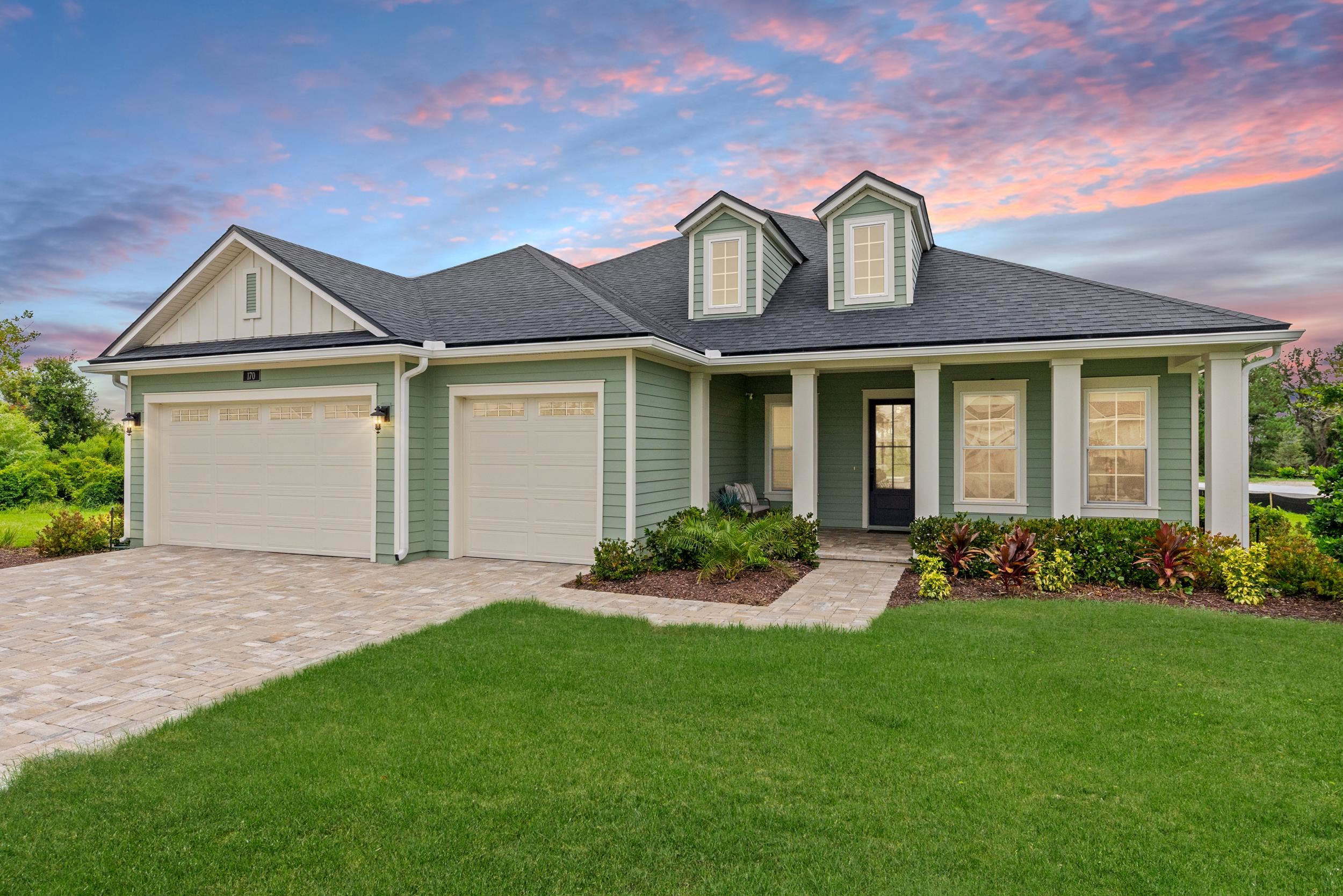 Light green siding exterior with a dark shingle roof Front Of Structure