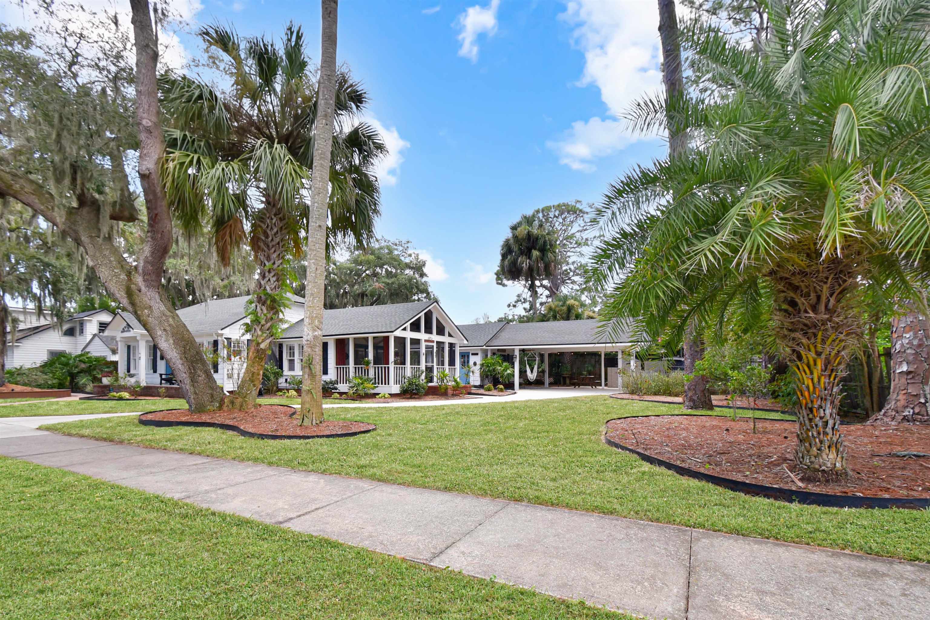 Expansive front lawn with mature trees and landscaping multi generational main house plus cottage