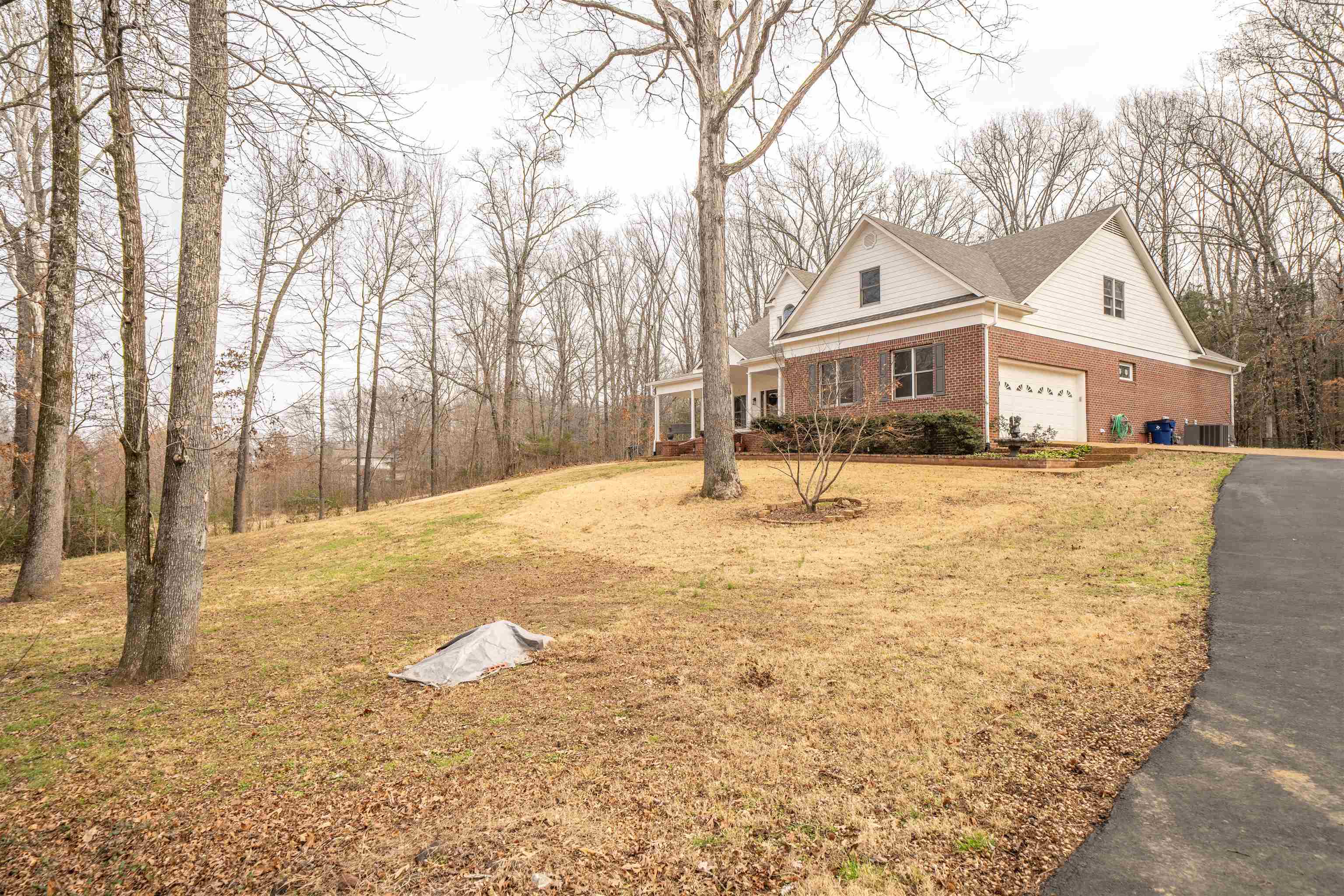 Luxury brick home on two private acres with a complete interior remodel and extensive upgrades. Recent improvements include exterior paint, new roof, new HVAC systems, new hot water tanks, and a newly repaved and sealed driveway. Spa-inspired bathrooms feature updated flooring, custom tile, granite countertops, new cabinetry, and designer fixtures. The primary bath offers a deep soaking tub and marble-tiled walk-in shower. Luxury vinyl tile flooring, smooth ceilings, and updated lighting elevate the main living spaces. The gourmet kitchen showcases quartz countertops, custom cabinetry, stainless steel appliances, a wine cooler, and a 6-burner gas range—perfect for entertaining. All bedrooms include private en-suite baths, providing comfort and privacy.An enclosed dining room or executive home office with front-facing windows adds flexibility. The home also includes a spacious bonus room and abundant walk-in, floored attic storage. Enjoy outdoor living on private screen porch.