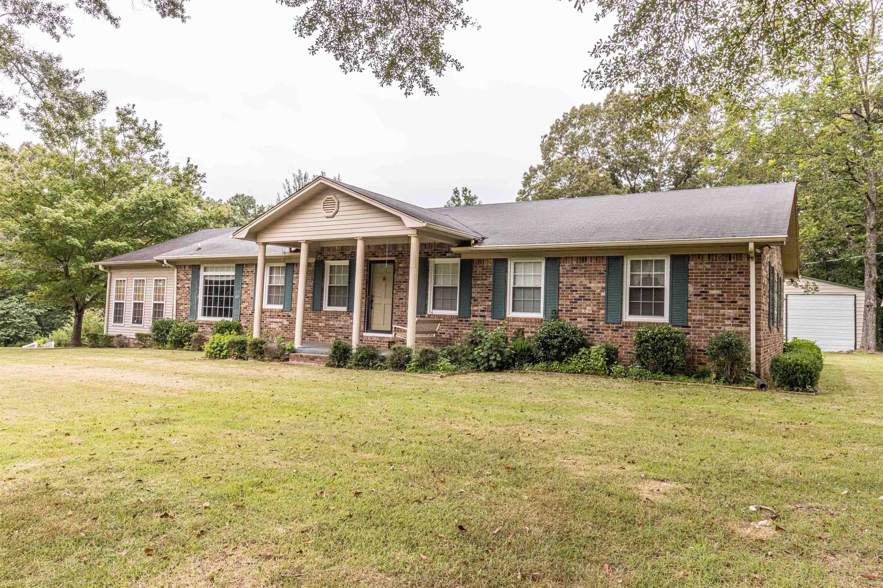 Great brick home with 3 bedrooms, 2 baths, large living room with gas fireplace, sunroom and great kitchen with appliances & joining dining room. Nice hardwood floors in most of the home & tile in bathrooms & kitchen-dining area. This home sits on approx. 3.2 acres and has a 30x40 large shop and also another small building. There is a nice paved driveway that leads to a carport. Great location, just minutes from downtown Selmer & shopping.