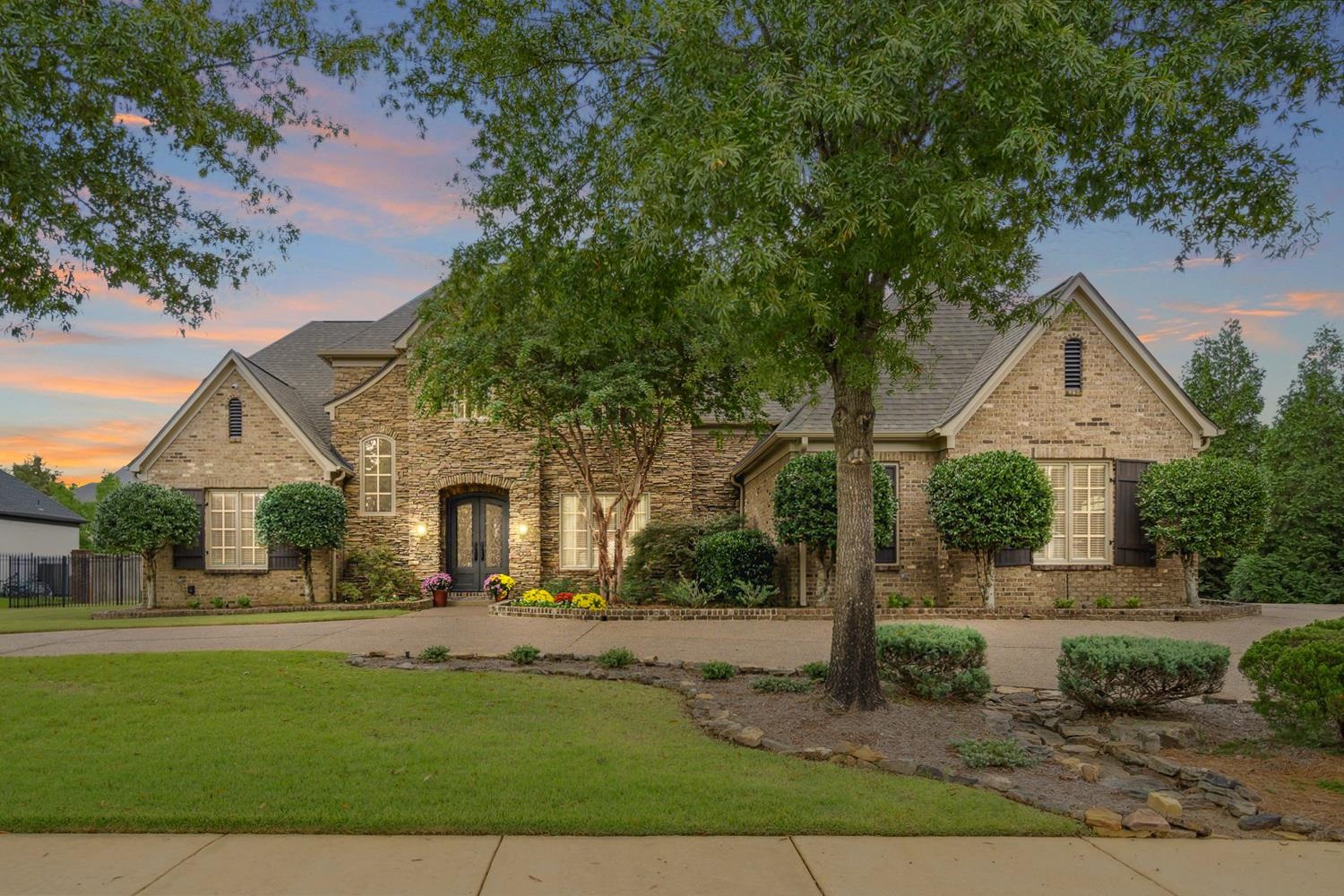 This showstopping, custom built John Worley home is 5 Bedrooms (2 Beds down), 4.5 baths + office, Bonus & Media Room - over 5900 sq/ft! Large lot on almost a 1/2 acre & a 3 car garage! Coveted Braystone Park has a neighborhood soccer field, pool, lakes & wide open green spaces for you to roam & mingle.  Meticulously cared for, Gorgeous hardwood floors, Handmade stone(Cambria)in Kitchen, Custom millwork, Soaring ceilings, Tuscan iron doors, Walk in & permanent attic stairs. Experience outdoor luxury w/ the exquisite Gunite pool, designed for relaxation & entertainment. The pool is perfectly complemented by a cozy wood-burning fireplace, offering warmth & ambiance for cool evenings. Additionally, enjoy gourmet grilling on the built-in Green Egg, ideal for creating unforgettable outdoor dining experiences.  Relax in the 4 season room year-round, this versatile room is perfect for entertaining, relaxing or enjoying the changing scenery.  NEW roof & freshly painted exterior! NEW pool pump!