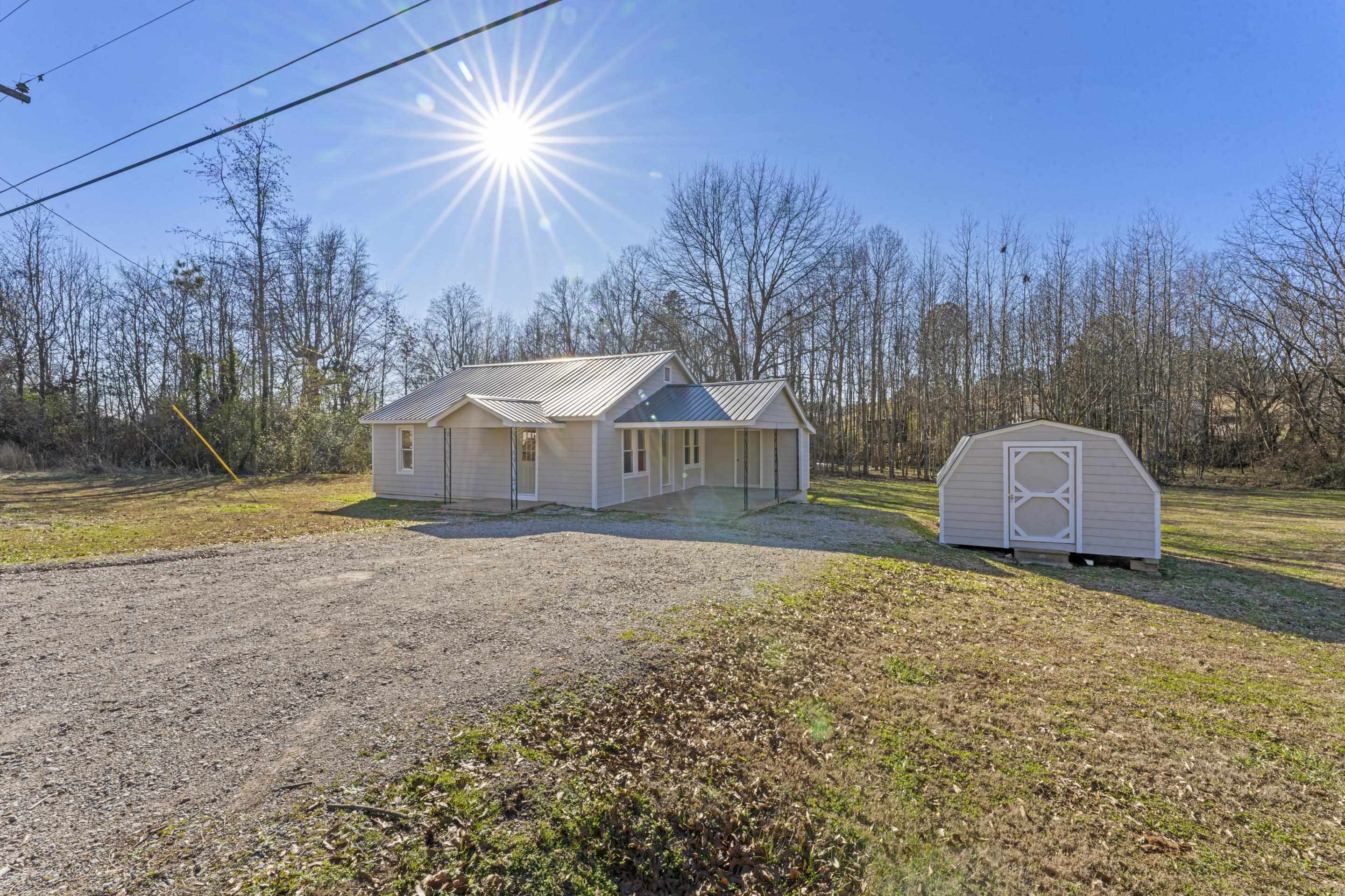 Discover the hidden potential at 580 Pine St, Selmer, TN 38375—a charming 1948-built single-family home nestled on nearly an acre of land. This 870 sq ft property offers 2 bedrooms and 2 bathrooms. It's an inviting space ready for you to make your own. Perfect for comfortable living, it provides the essentials in a cozy layout.  Move-in ready and beautifully updated, this home features new flooring and fresh paint throughout, creating a modern and inviting space. The light and plumbing fixtures have been upgraded for a contemporary feel. Enjoy updated bathrooms with stylish tile work, adding a touch of elegance to your daily routine. Shed included for additional storage.  This home is ready for you to enjoy right away!