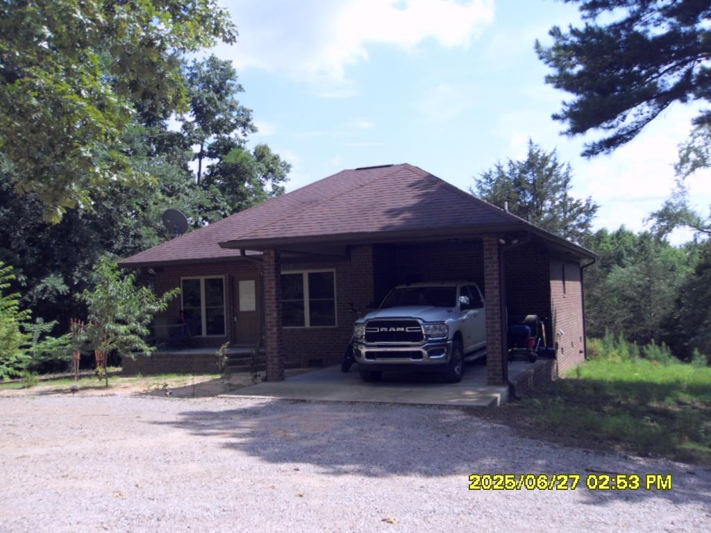 15 acres with secluded 3 bedroom 2 bath brick hill top home non visible from the road.  Privacy galore! Open kitchen, great room and dining area. Kitchen has eat on bar with all appliances remaining, including washer and dryer. Split bedroom floorplan with private primary suite.  Primary bath offers large soaking tub, separate shower and double vanity.  2 additional bedrooms, large hall bath and separate laundry/mud room.  Circle drive and additional drive to large 24x24 shop with open bay and concrete pad to roll up door section.  Side walk thru door for convenience.  Small pond on front of property, with plenty of land to create your own dreams. Fruit trees surround the circle drive.  Plenty of firewood for your firepit too. Enjoy the beautiful woods from every window in the home, or relax on the covered back porch enjoying the surrounding nature.  This home is move in ready and waiting for it's new family to enjoy.  Call to schedule your showing today.