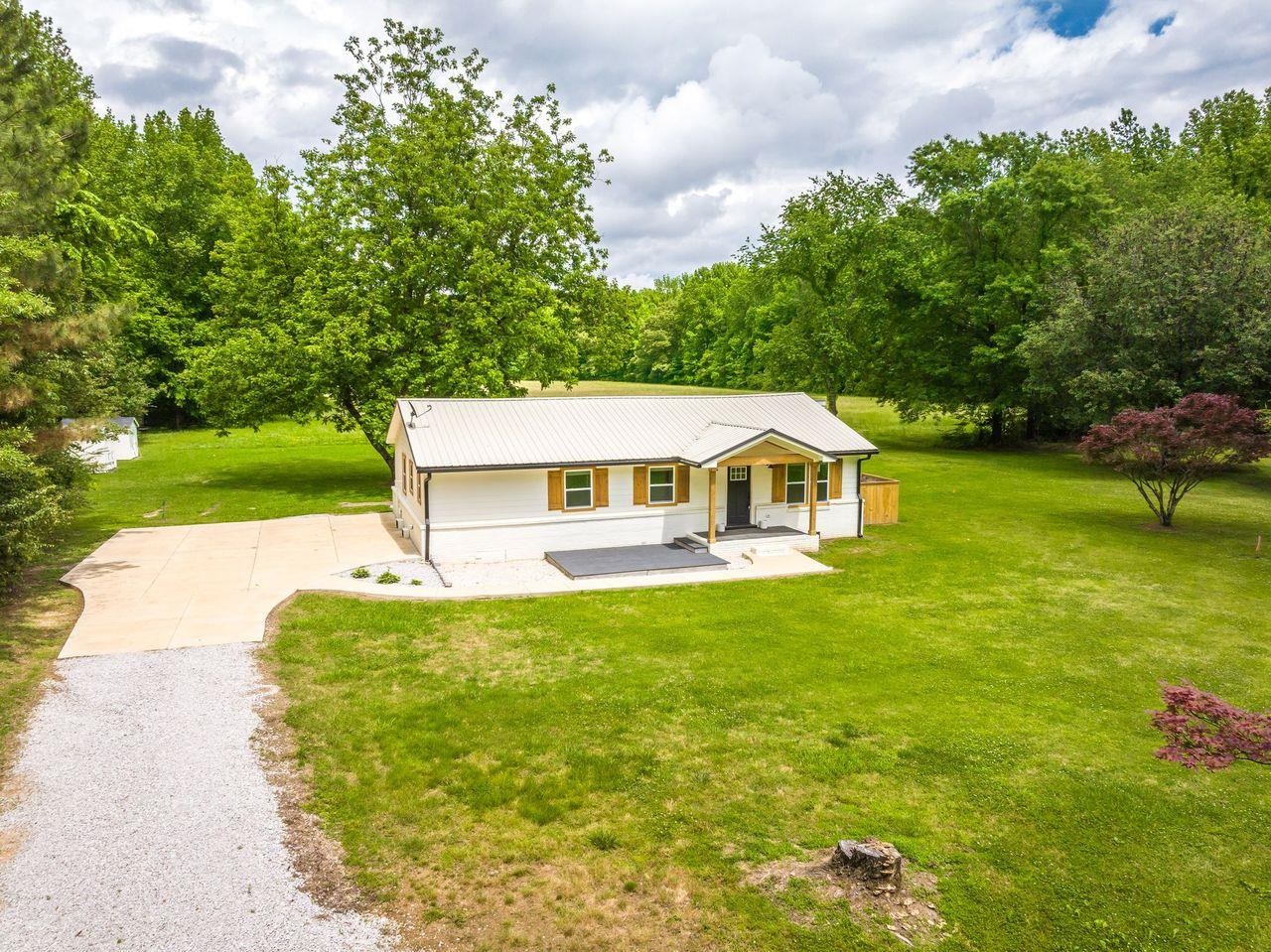 Custom '22 Remodeled Home on 1 Peaceful Acre (additional 25.6 acres available for purchase - options: live here & build your estate home/in-laws/growing/ downsizing). Tongue & Groove Covered Front Porch, Hybrid deep cut marble counters, Wainscoting decorative trim, LVP & Tile flooring, Coffee bar, Floating shelves. Open living area. Kitchen w/Large 5X7 Island w/cabinets & electrical, Electric Flat top range, Pot filler, Vent-a-Hood. Primary - Sliding barn doors, decorative lit cutouts for desk and/or dresser, 2 closets/1 Large walk-in Closet. Luxury Primary BA - Soaker clawfoot tub & Double sink vanity w/high end countertop. 2nd BR - Custom bed wall unit for Kids or Grandkids + wooden closet shelving. Hall BA- Walk-in shower w/Dual heads & Glass doors. Exterior: Metal roof, Gutters, Front patio deck, Fire pit, 2 storage buildings/1 w/built-ins & counterspace, Walk-in Chicken coop w/4 nesting boxes. Schedule your showing today to experience all this property has to offer! OWNER / AGENT.