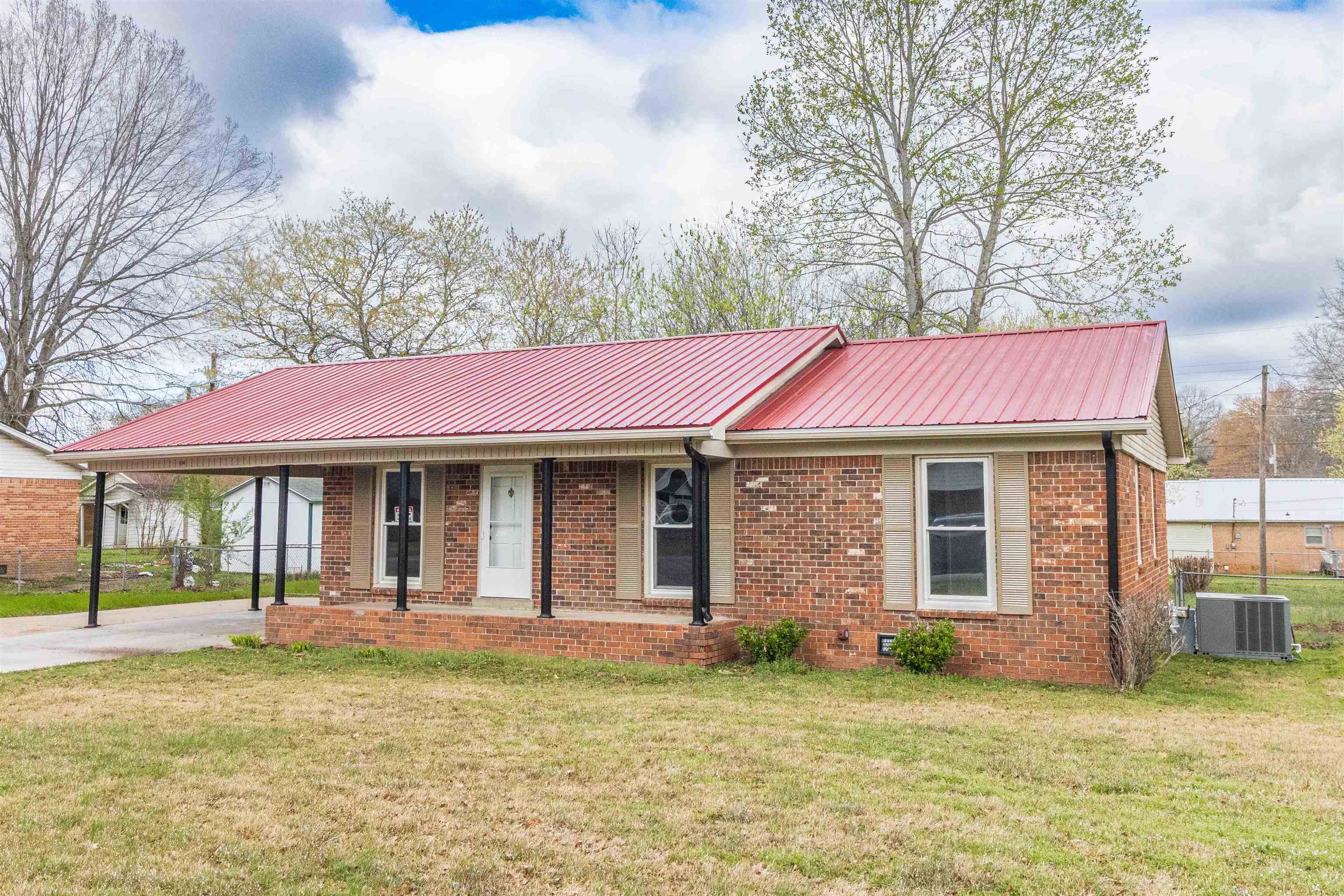 Remodeled brick home in nice quiet neighborhood.  Updates include windows, lighting, flooring and paint throughout, new french door leading to back deck & fenced backyard.  Storage building and carport.  Concrete driveway. Front porch. Home move in ready with tasteful modern details. Metal roof installed few years ago. Great starter or retiree home.