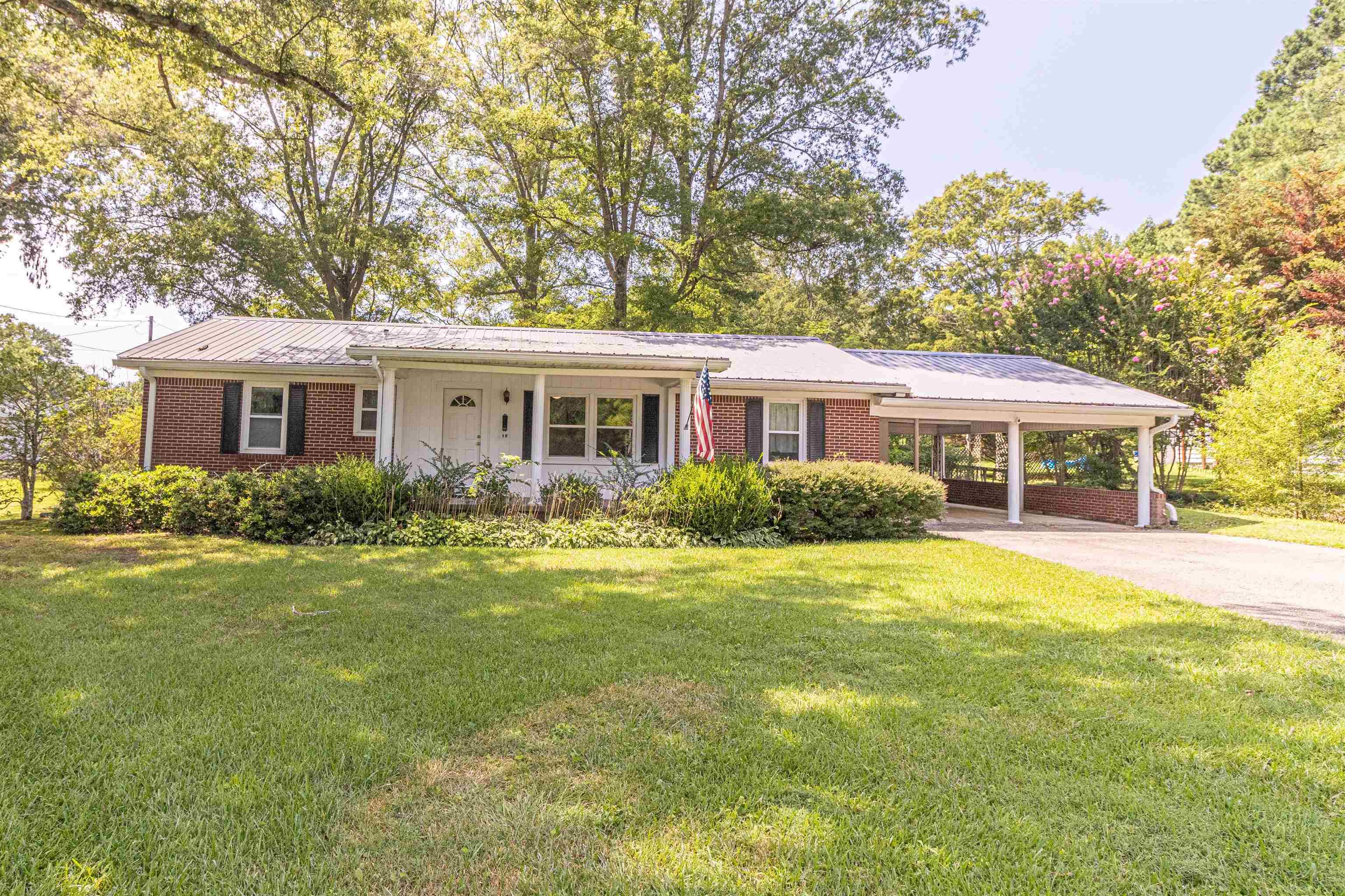This beautifully remodeled 3 BR,1.5 BA Brick home is a MUST SEE!. The home has a new metal roof, new vinyl windows, new lighting, new interior paint, new kitchen cabinets(white Shaker)w/island, pantry, Quartz counter tops, new Kitchen Aid Stainless Steel Appliances, (Downdraft Cookstove) & washer & dryer. Remodeled Bath with tile tub & shower, new exterior doors, insulated back porch, 16x24 Metal Stg. Bldg. 10x12 Bldg. Located on a beautiful acre lot. Call today for your showing.