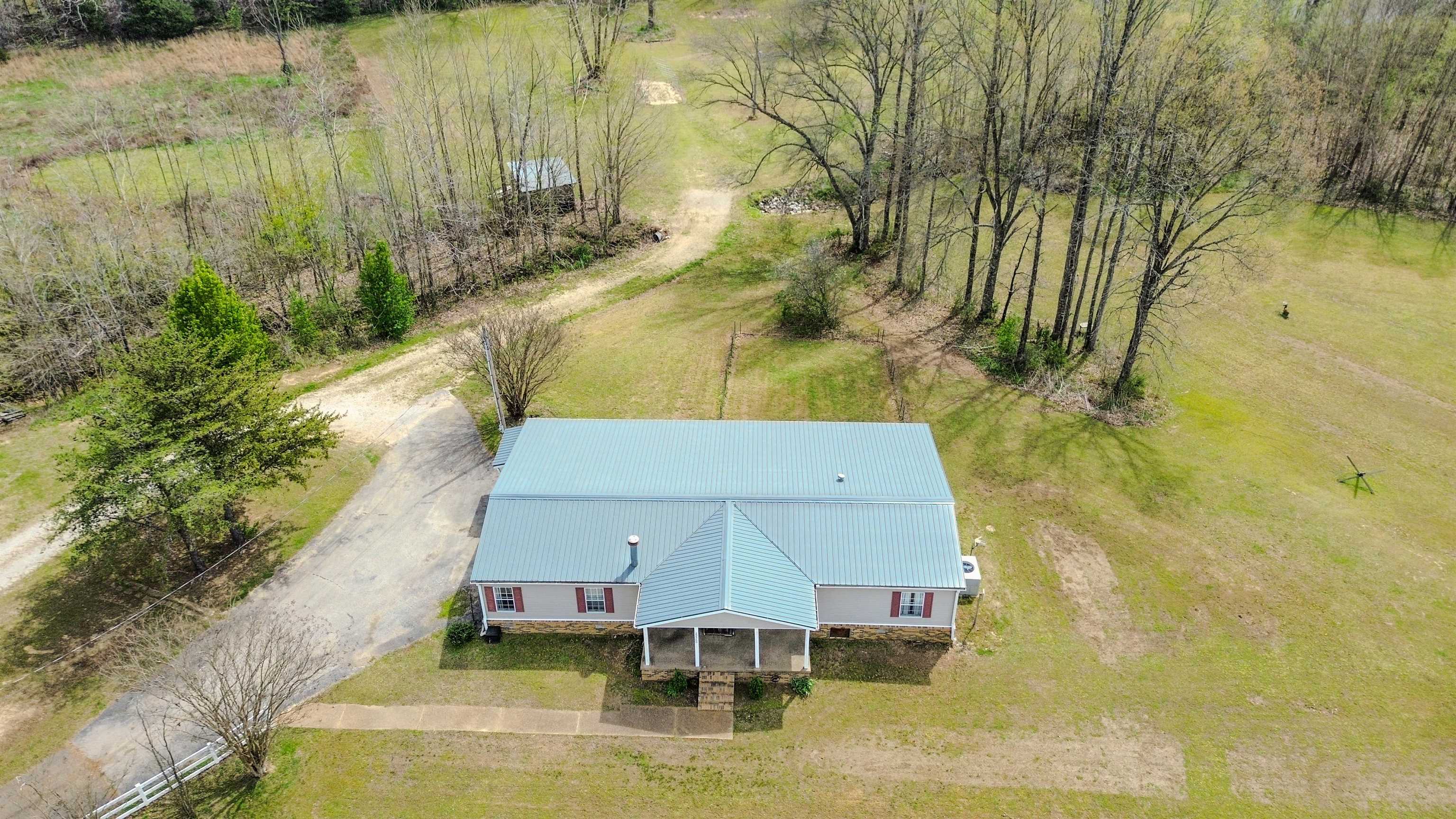 If you’ve been lookin’ for a true outdoorsman’s place, this one right here in Somerville, TN is hard to beat. This property has a 3 bed, 2 bath 2,300 sq. ft. home, a 20x20 shop and sits on 33 acres that’s been carefully managed for deer and turkey for years. You’ve got established food plots, multiple stands and blinds, and even your own shooting range ready to go. The property backs up to the Loosahatchie River on the west side, which brings in all kinds of wildlife. There are ATV trails cut throughout, making it easy to get around and enjoy every bit of it. There’s also a stocked 1-acre pond perfect for fishing whenever you feel like it. On the east side, you’ll find 3+ acres of partially fenced pasture, great for a few animals or just open space. Plus, you’ve got two potential homesites, one already set up with water and electric. Whether you’re huntin’, fishin’, or just want some peace and quiet, this place gets it done. *INTERIOR PHOTOS COMING SOON*