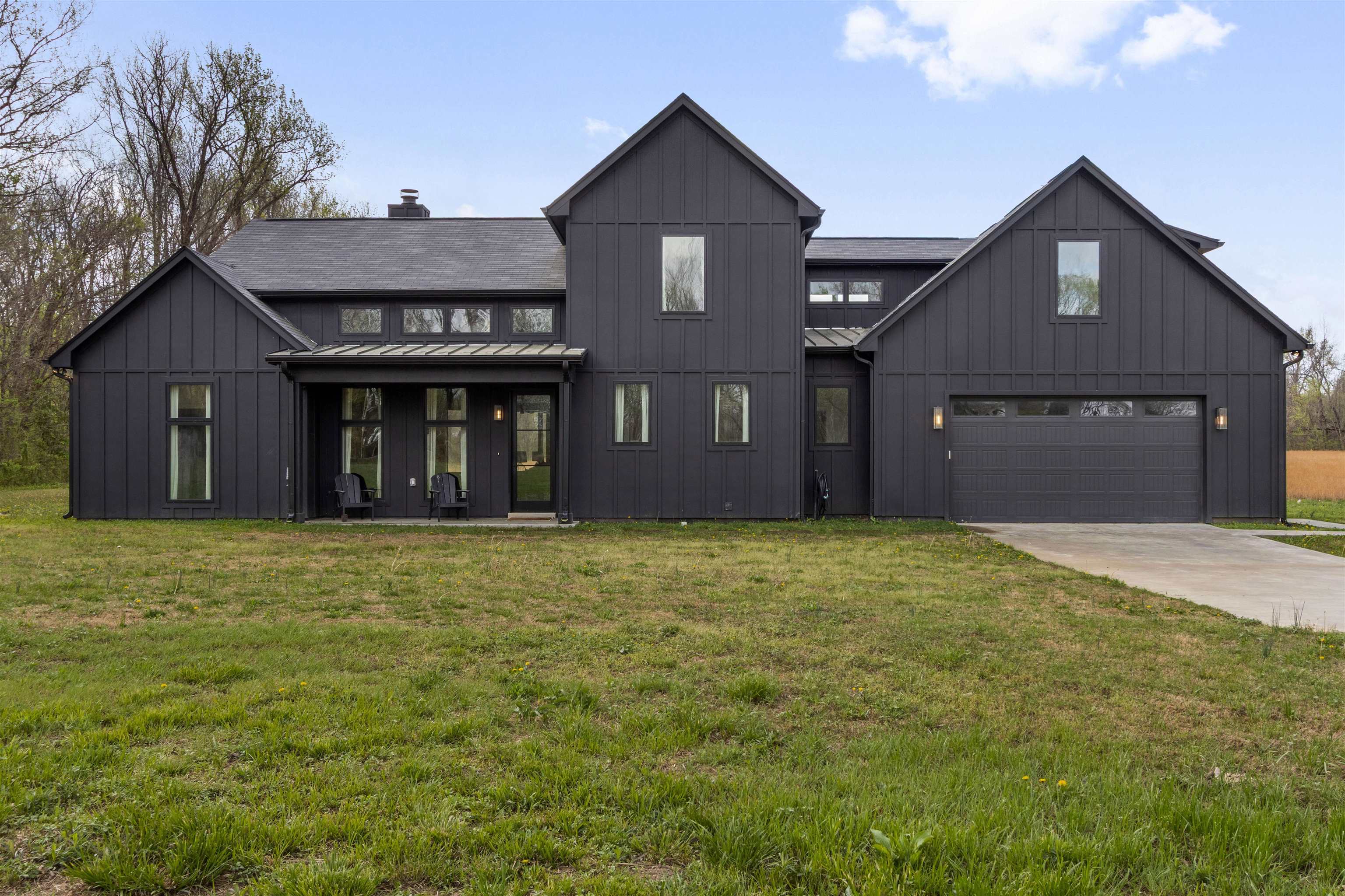 Welcome to this custom-built retreat, where luxury living meets the beauty of nature. Designed for comfort & connection to the outdoors, this 3BD + bonus, 2.5BA home features a modern design with striking exterior. The open floor plan is anchored by a breathtaking great room with soaring ceilings, built-ins & a fireplace, while expansive sliding doors open to a screened porch & patio spanning the length of the home. The kitchen overlooks the living & dining areas & impresses with a massive island & hidden walk-in pantry. The main-level primary suite offers porch access & a spa-like bath featuring dual vanities, soaking tub & walk-in shower. A home office & convenient 1/2 bath complete the main level. Upstairs, a spacious bonus offers flexibility. Surrounded by open land & peaceful views, enjoy seamless indoor-outdoor living. With convenient access to Fayette Academy & Somerville Town Square, this exceptional property offers the perfect blend of privacy & elegance!