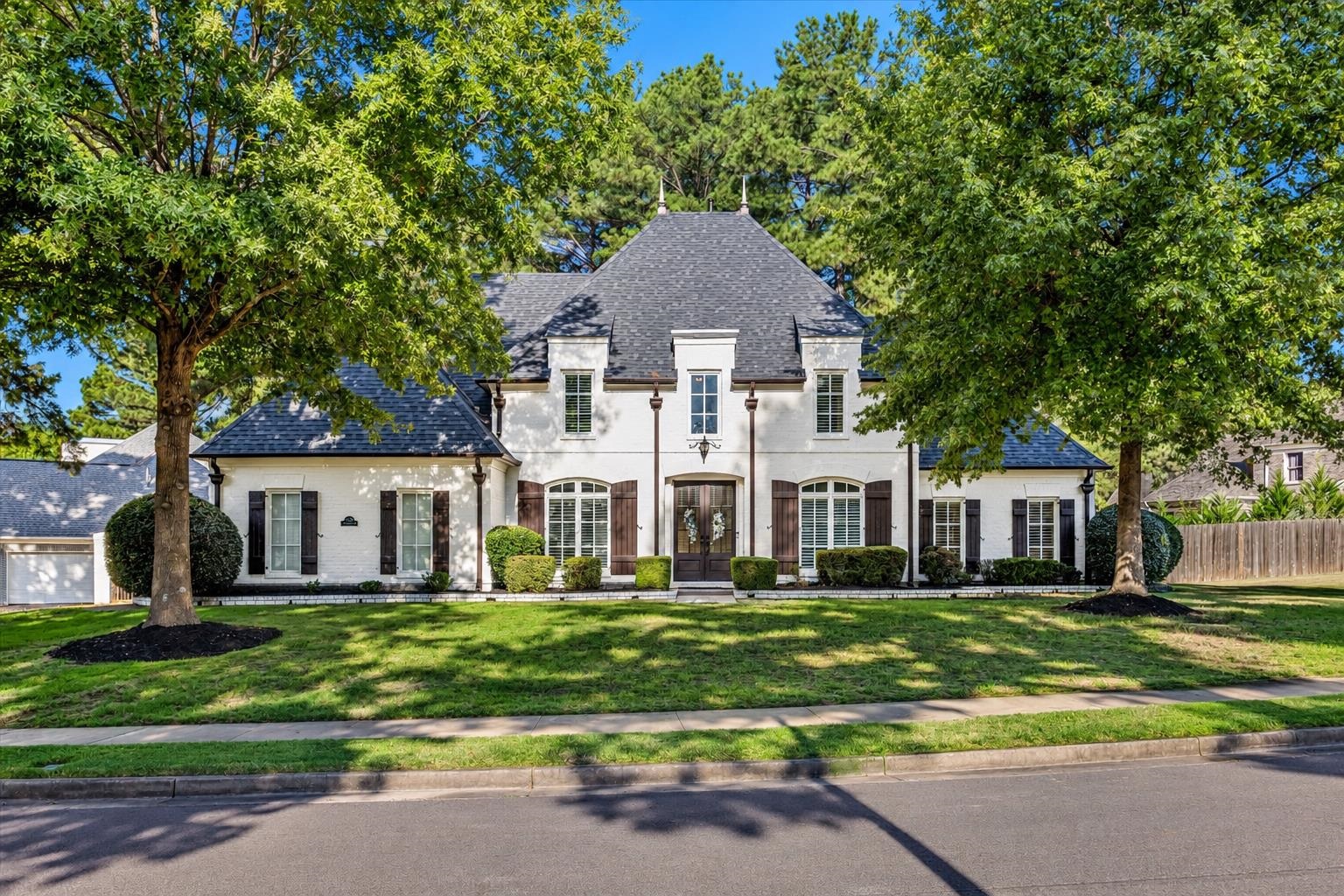Must-see, move in ready gem in one of Collierville’s charming upscale neighborhoods! Situated on a 1/2+ acre corner lot, this beautiful home offers 4 bdrms + Bonus room, 3.5 bths & 3-car side-load garage! Freshly painted neutral interior, hardwood floors & brand-new carpet throughout. The inviting kitchen features granite countertops, breakfast bar, double ovens, cooktop & eat-in area. Just off the kitchen, the cozy hearth room boasts a fireplace & built-in bookcases. A large den & formal dining room offer plenty of space for entertaining. Bright & sunny 4 season room overlooks the backyard! Spacious primary suite features a huge walk-in closet & luxury bath w/ double vanities, walk-in shower & jetted tub. Large laundry room provides extra convenience. Enjoy outdoor living on the expansive patio w/ built-in firepit, perfect for cool evenings! Privacy fencing w/ an iron gate adds charm to the backyard. Neighborhood pool to enjoy all summer long! Beautifully maintained & waiting for you!