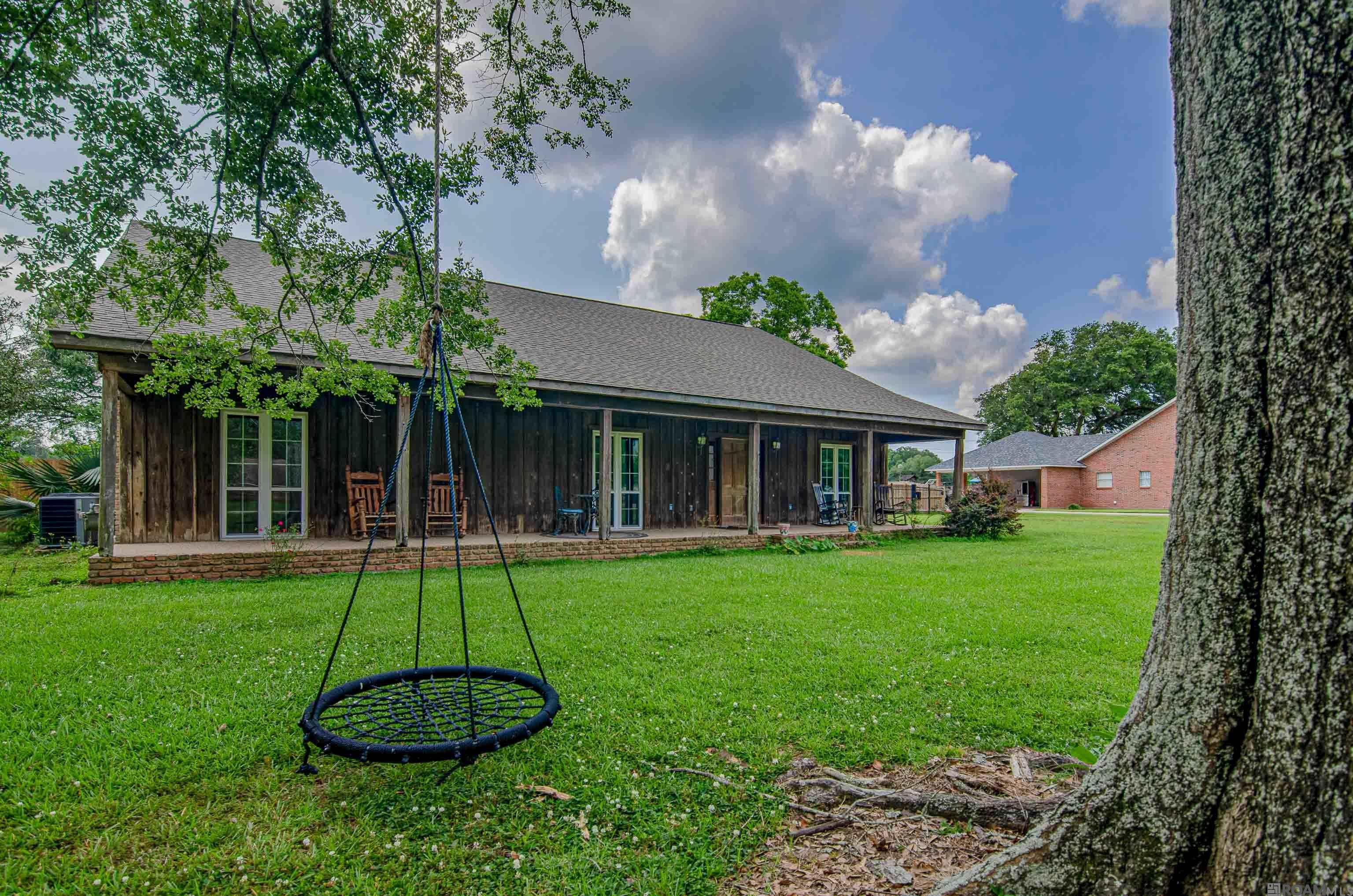 Discover a rare gem in the heart of coveted Lafitte Hills, just off historic Highland Rd. --- one of Baton Rouge's most charming and established neighborhoods. Nestled on a expansive lot, this spacious 4 bedroom, 3.5-bath home offers timeless character and incredible potential. Inside, you will find wood floors, soaring beamed cathedral ceilings, and a welcoming living area with a cozy fireplace. The functional layout includes an office, sunroom, and wet bar--prefect for entertaining or everyday living. Recent updates such as a new HVAC system and energy-efficient windows provide a head start for your personal touches. Step outside to a new fully fenced backyard, a large workshop or storage area off the carport. There is endless room to create your dream outdoor retreat. With a little TLC, this classic property can be transformed into your forever home or next golden opportunity. In a neighborhood where homes rarely become available, this is your chance to make Lafitte Hills your own! Act quickly-----opportunities like this are fleeting!