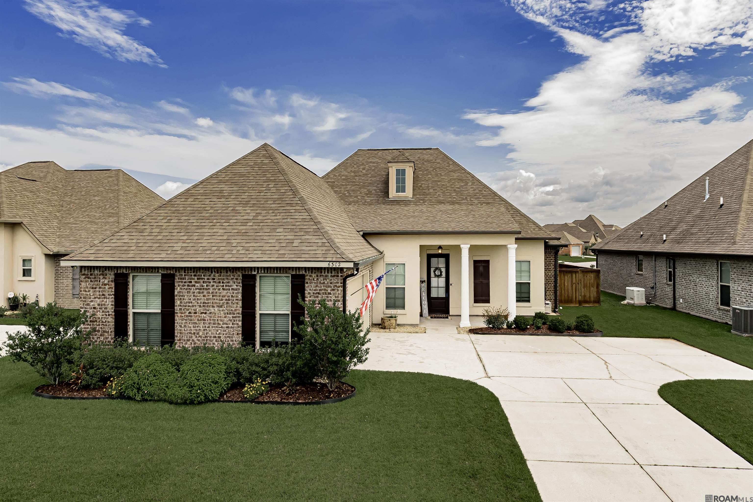 JUST LIKE NEW & Priced to MOVE!   This beautifully charming and upgraded home—featuring some upgrades no longer available from the builder—offers luxurious living in Flood Zone X! The bright, open floor plan is highlighted by abundant natural light, custom built-ins surrounding the fireplace, gorgeous french doors from the chef's kitchen to outdoor kitchen, granite countertops, subway tile backsplash, and an oversized island ideal for all of your gatherings!   Enjoy the outdoor living area complete with a covered patio, fully equipped outdoor kitchen, extended textured concrete, lush landscaping, and peaceful lake views. It’s an entertainer’s DREAM inside and out.  A thoughtful triple-split layout ensures generous bedroom spaces, plenty of storage options and a tranquil oasis for all. The living to kitchen and dining is open, leaving plenty of room to host holidays and events without missing a moment while prepping in the kitchen!   Immaculately maintained, move-in ready and filled with so much character—don’t miss your chance to see this one! Schedule your showing today.