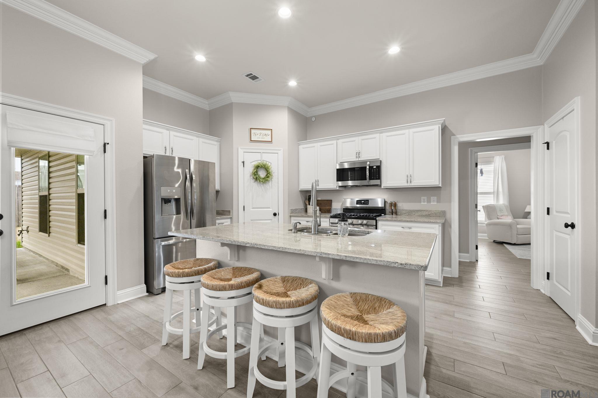 The wait is over — this one checks all the boxes… and then adds a few more. Welcome to 14429 Sterling Oaks Drive, a 3-bedroom, 2-bath home situated in Gonzales and officially available now. Standout elements include location, condition, and layout, setting this property apart from others in the market. Conveniently positioned near Airline Highway and just minutes from I-10, this home offers easy access to everyday destinations and surrounding parishes, including: (15 minutes to St. Gabriel, 30 minutes to Downtown Baton Rouge, 30 minutes to St. John Parish). Unlike many homes in the area, this property is truly move-in ready. Built less than five years ago, it features a post-tension slab, Low-E windows, gas range and a tankless water heater, offering both efficiency and peace of mind. Designed for everyday comfort and effortless entertaining, the functional layout supports relaxed family living while seamlessly accommodating gatherings and celebrations. Additional highlights include an enclosed garage, covered patio, privacy fence, along with stainless steel appliances, granite countertops, and wood-look tile flooring throughout, creating a space that feels both refined and practical. This home offers the perfect blend of comfort, value & lifestyle.