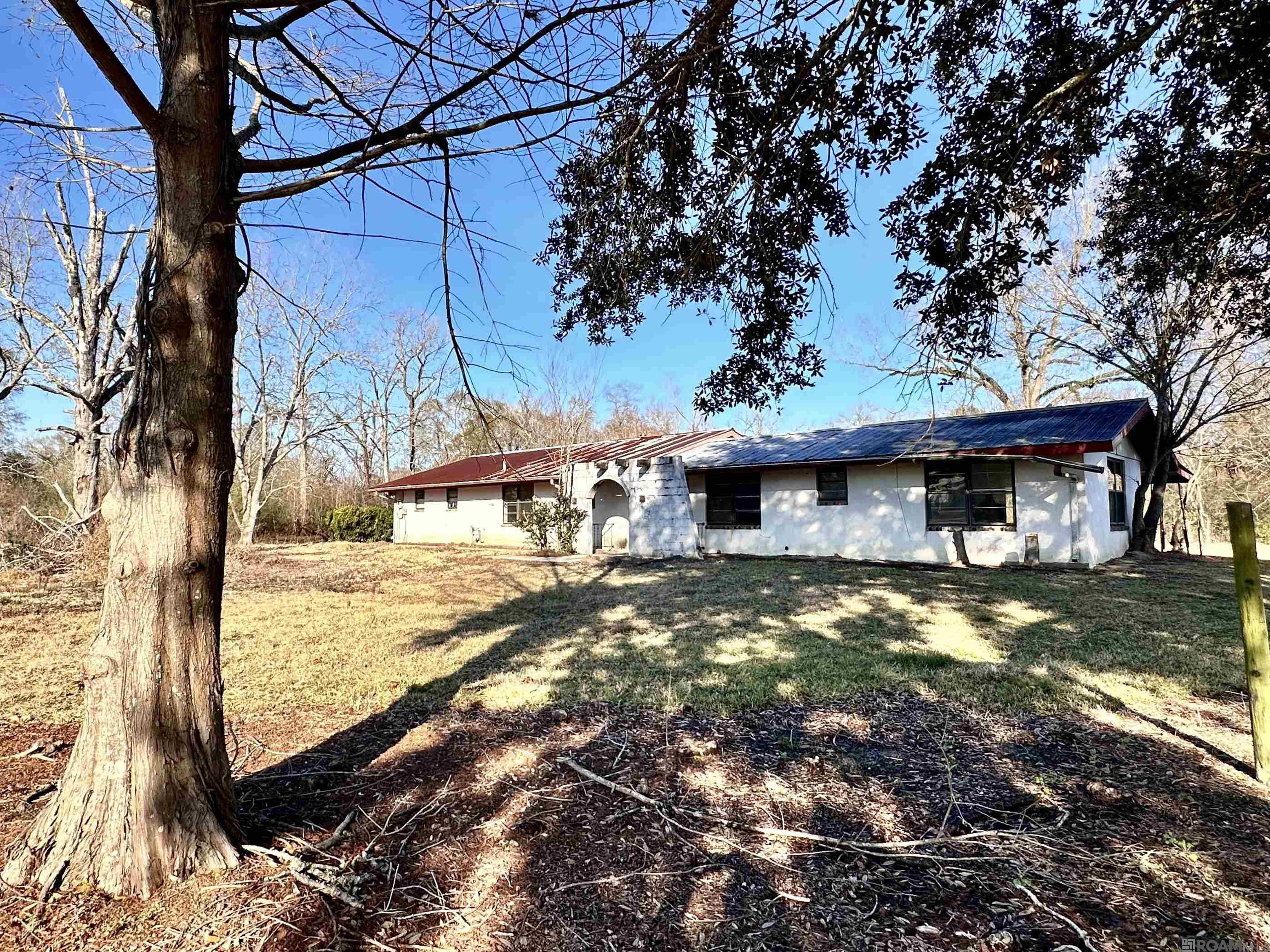 Great Investment Opportunity on Nearly 2 Acres! 14126 Roddy Rd, Gonzales, LA 70737 Spanish-style 2BR/1BA home located on almost 2 acres in Ascension Parish adjacent to Central Middle School. The property offers approximately 2,500 sq ft under roof, fireplace, enclosed garage, and large covered porches. The home is ready for updates and offers excellent potential for the right buyer. Property has never flooded. Showings by Appointment only, please do not enter property without an appointment. Cash offers only - Sold "As-Is' - Seller will not make any repairs.