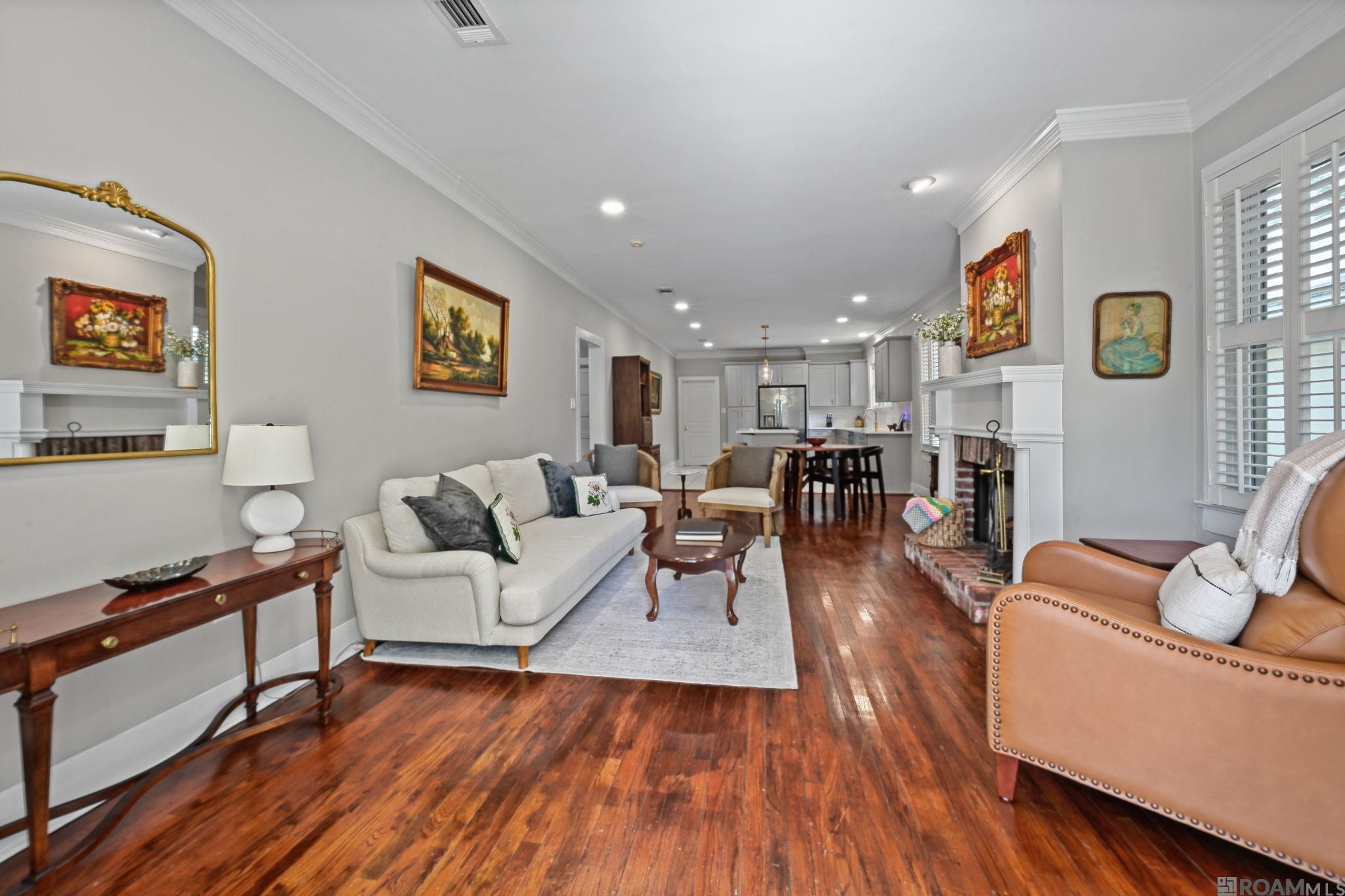 Welcome to this adorable Mid City gem, where timeless charm meets modern updates that has a BRAND NEW ROOF,  EXTERIOR PAINT and OPERABLE DOUBLE PANE NEW WINDOWS! Nestled in one of Baton Rouge's most desirable neighborhoods, this beautifully renovated and expanded 3-bedroom, 2-bath home offers endless possibilities as a primary residence, Airbnb, or income-producing property. The spacious rear suite could easily be converted into a private apartment with its own kitchen, laundry, full bath, and walk-in closet, creating an excellent opportunity for dual-income potential. The stunning chef's kitchen features quartz countertops, a gas range with griddle and downdraft vent, soft-close cabinetry, gold fixtures and hardware, and an under-mount sink. A split floor plan offers two front bedrooms that share a beautifully renovated bath with a glamorous vanity and classic black-and-white tile floors. Original character shines through with oak flooring, nine-foot ceilings, double crown molding, plantation shutters, cypress construction, and two inviting front porches. The interior has been sheet rocked while preserving the original shiplap underneath. Major updates include plumbing, electrical, insulation, a brand-new roof, and a freshly repainted exterior, providing added peace of mind. The private primary suite offers a large walk-in closet, oversized flex room perfect for an office or sitting area, en suite bath, and access to the covered back porch and fully fenced backyard. Enjoy your morning coffee overlooking the beautifully landscaped yard or take advantage of the unbeatable location just steps from Capital Heights' biking and walking paths. This PRECIOUS Capital Heights cottage is just what you have been looking for!