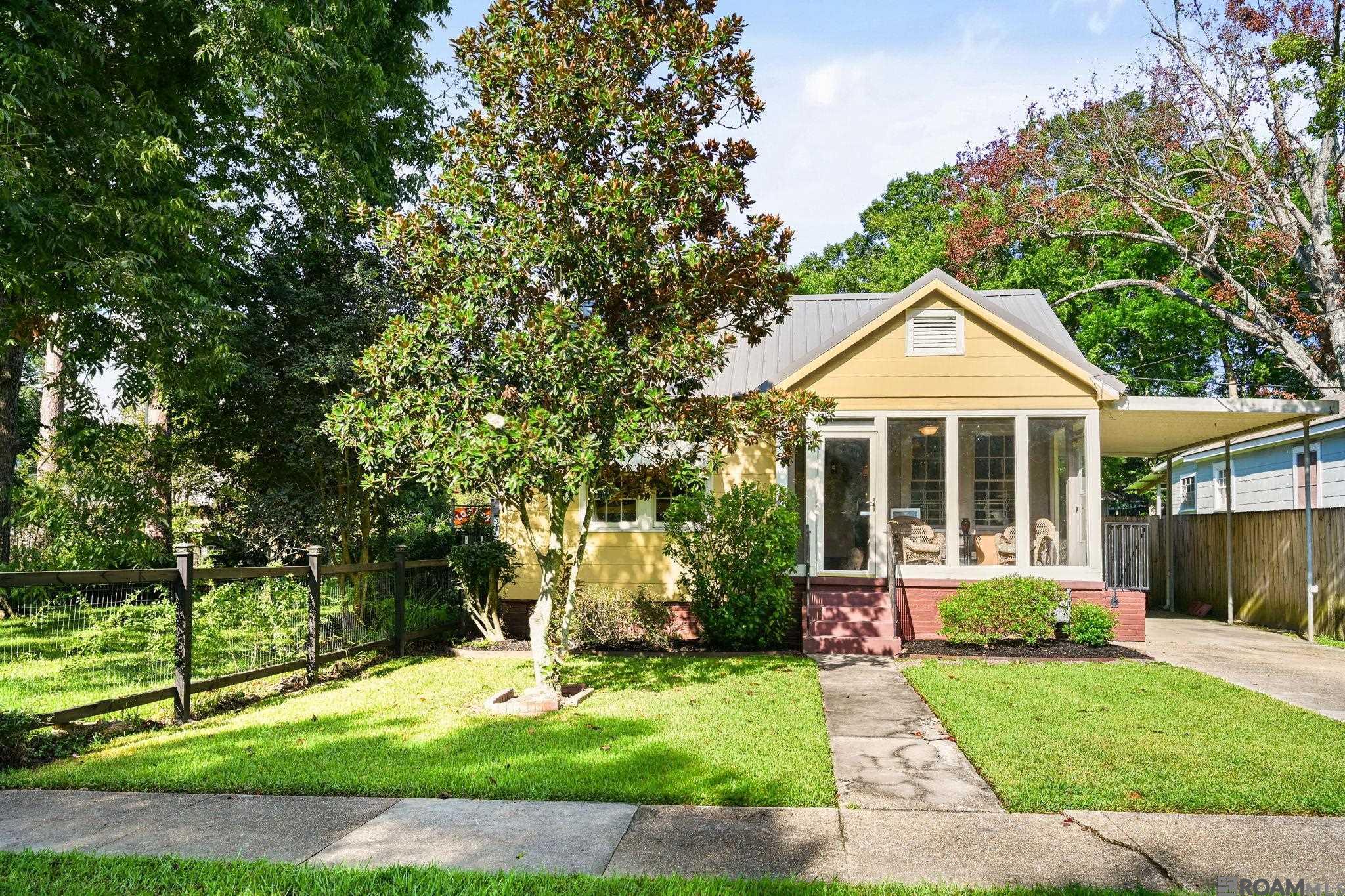 Charming cottage full of character in a fantastic location! This 2-bedroom, 1-bath home beautifully blends original charm with thoughtful updates. The kitchen was updated in 2020 with new cabinetry, an island, granite countertops, stainless steel appliances, and a 5-burner gas cooktop. Additional updates include a complete electrical rewiring, all new plumbing in kitchen and laundry room, tankless water heater, all completed in 2020. Original hardwood floors add warmth and character throughout the living room, dining room, hallway, and both bedrooms. The enclosed front porch is heated and cooled and included in the living area, providing additional flexible living space. The outdoor spaces are equally inviting with a fenced backyard and covered side porch. A detached 243-square-foot bonus room offers even more versatility and features insulated walls, a wall-mounted AC unit, and an electric fireplace heater. Use it as a home office, game room, art studio, or additional flex space. The main house also features a lifetime metal roof installed in 2005. Conveniently located within a short walk of Catholic High, St. Joseph’s Academy, and Government Street, with easy access to I-10, downtown Baton Rouge, LSU, the Garden District, and the Perkins Road Overpass area. A wonderful opportunity to own a character-filled cottage with important updates, flexible bonus space, and an exceptional location!