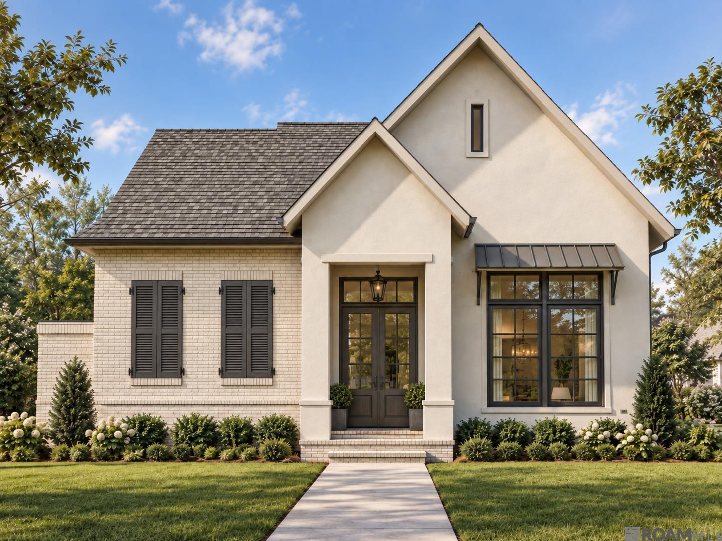 Light-colored gabled house with black shutters, dark-framed windows, and a landscaped front lawn.